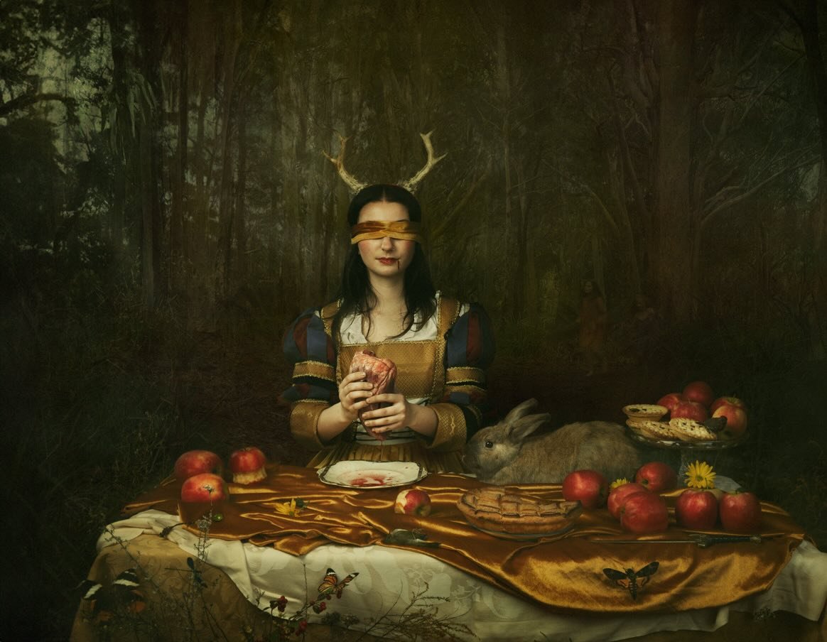 &lsquo;Supper With Snow White&rsquo;
She enters the forest like a pilgrim - seeking truth. No longer the child Snow White, but a re-wilded, (slightly feral) maiden. Whether it&rsquo;s the Queen&rsquo;s heart she&rsquo;s about to feast on or someone e