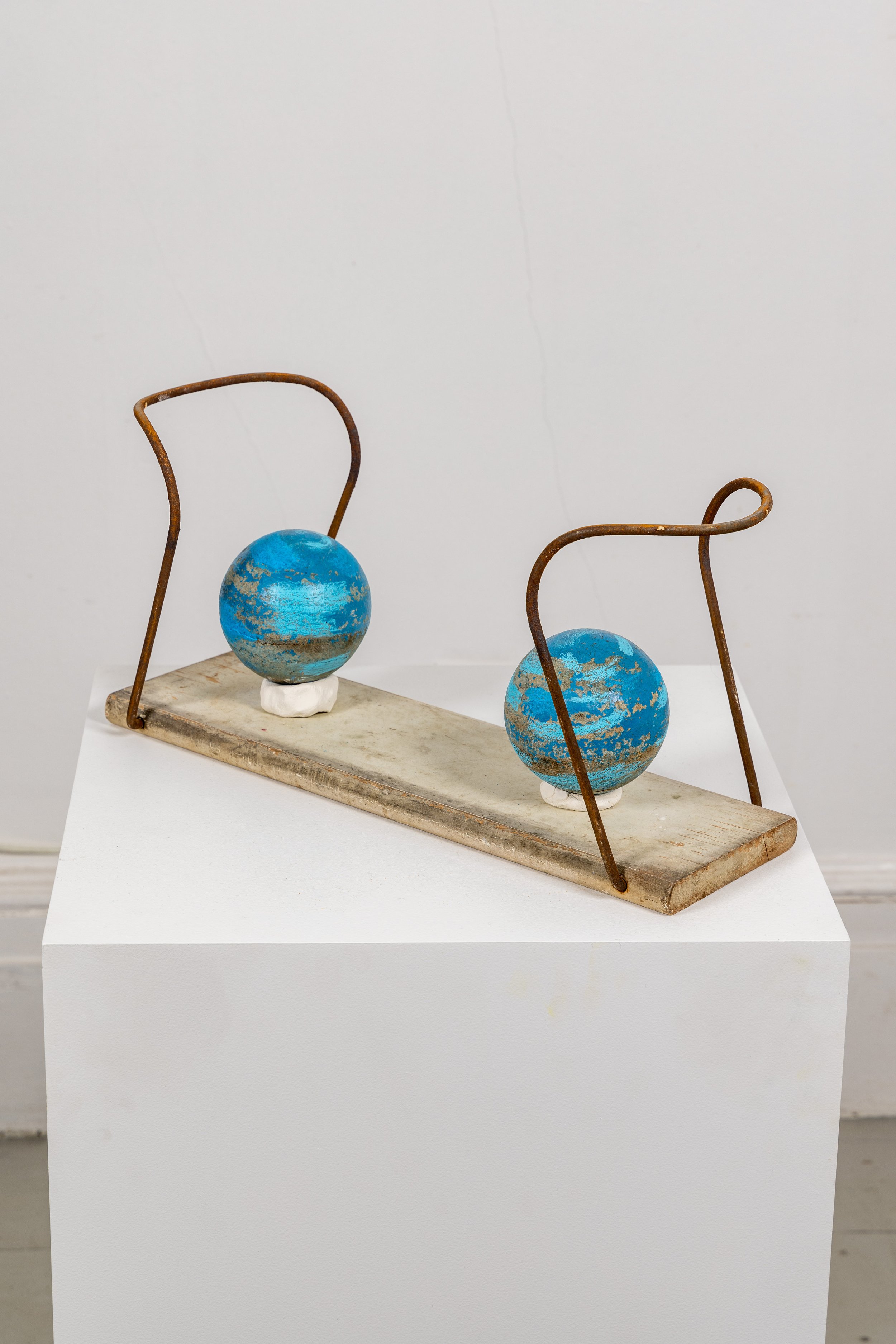 Elisa Lendvay, Sit and spin (celestial bodies apart) 2021,wood, steel rod, clay, bocce balls, latex and oil paint, 9 x 19 x 7 inches