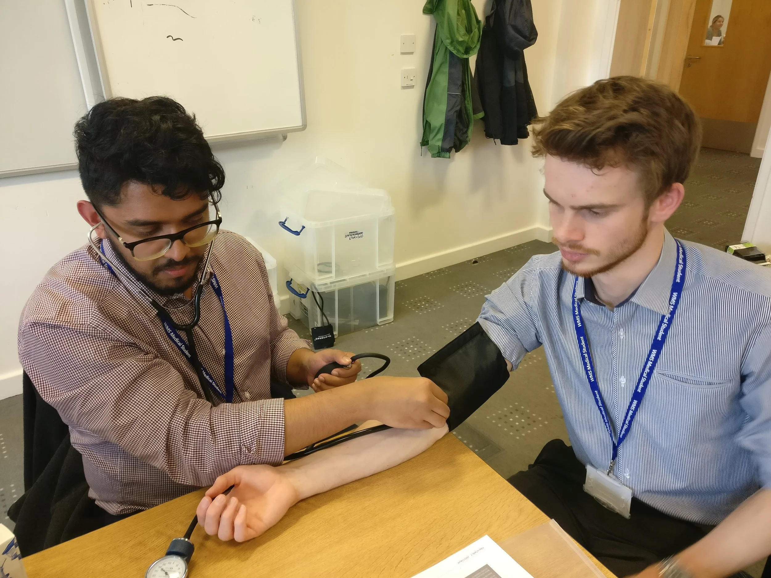 Taking blood pressure using a stethoscope and sphygmanometer