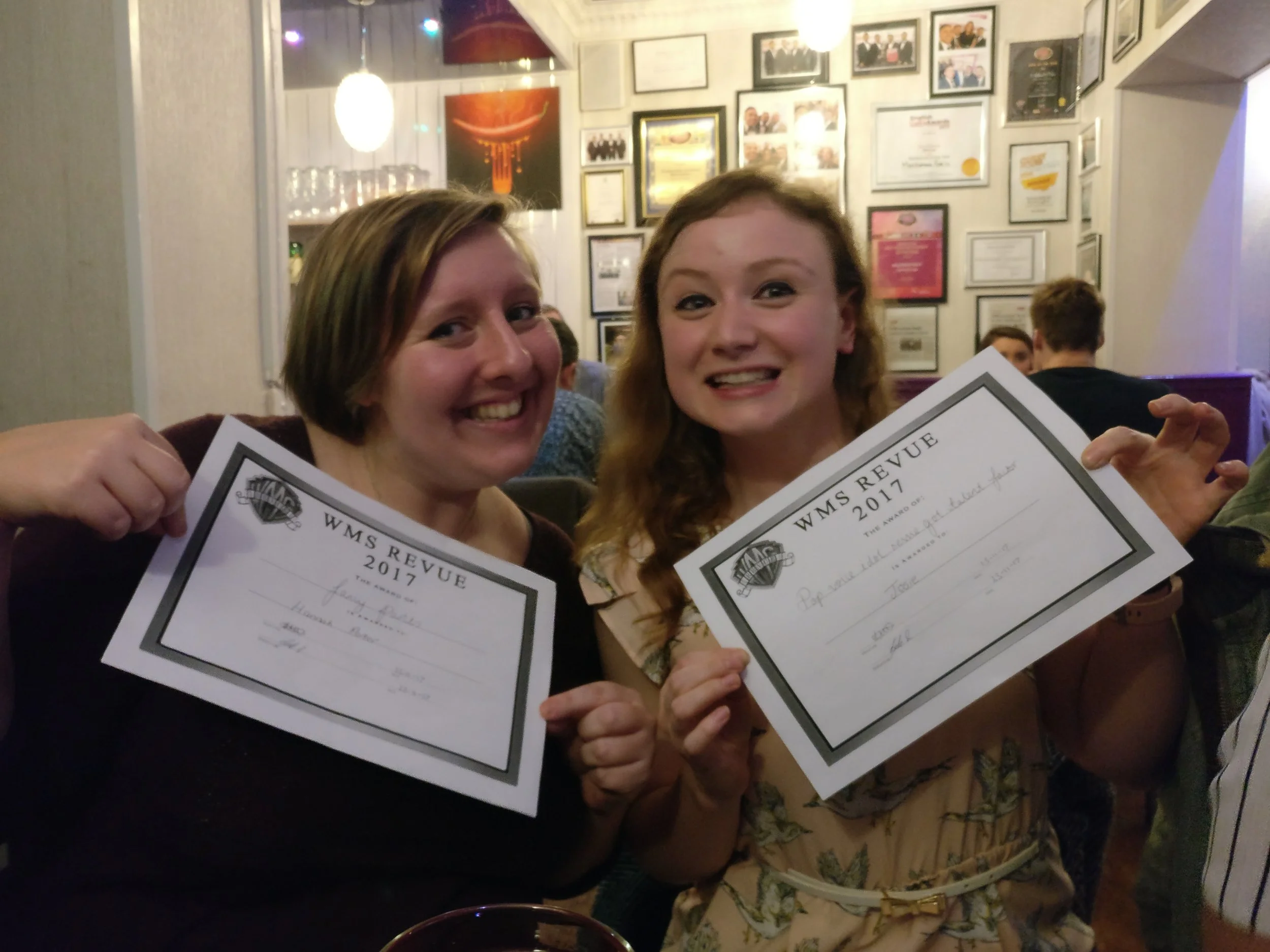 Two cast members with their peer-nominated awards ('Fancy Pants - Best Costume' and 'Best Vocals')