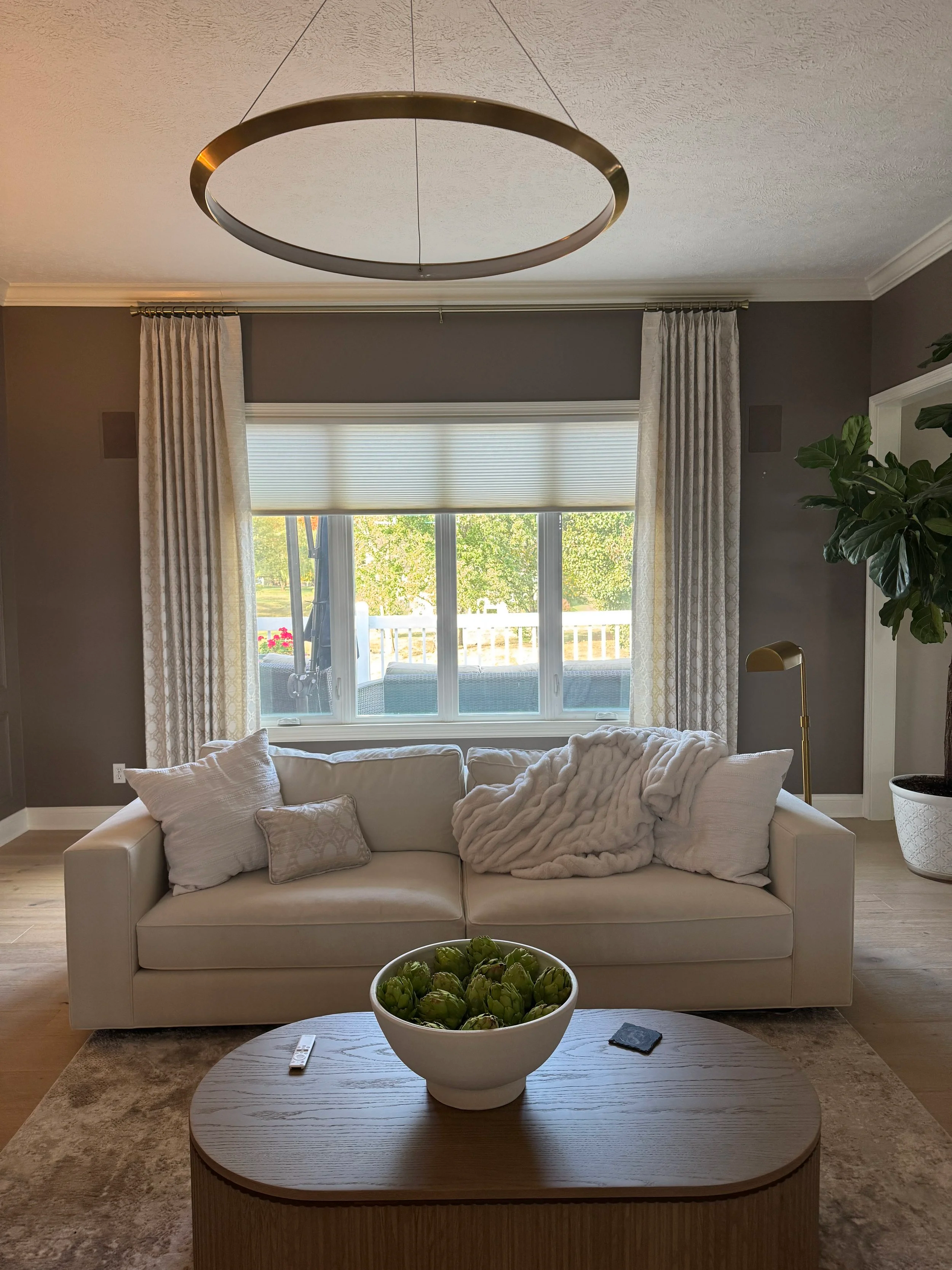  Hunter Douglas Duette® honeycomb shade in the popular Elan light filtering fabric provides UV protection and energy efficiency while custom Carole Fabrics side panels mounted on Kirsch hardware bring elegance and softness to the room. 
