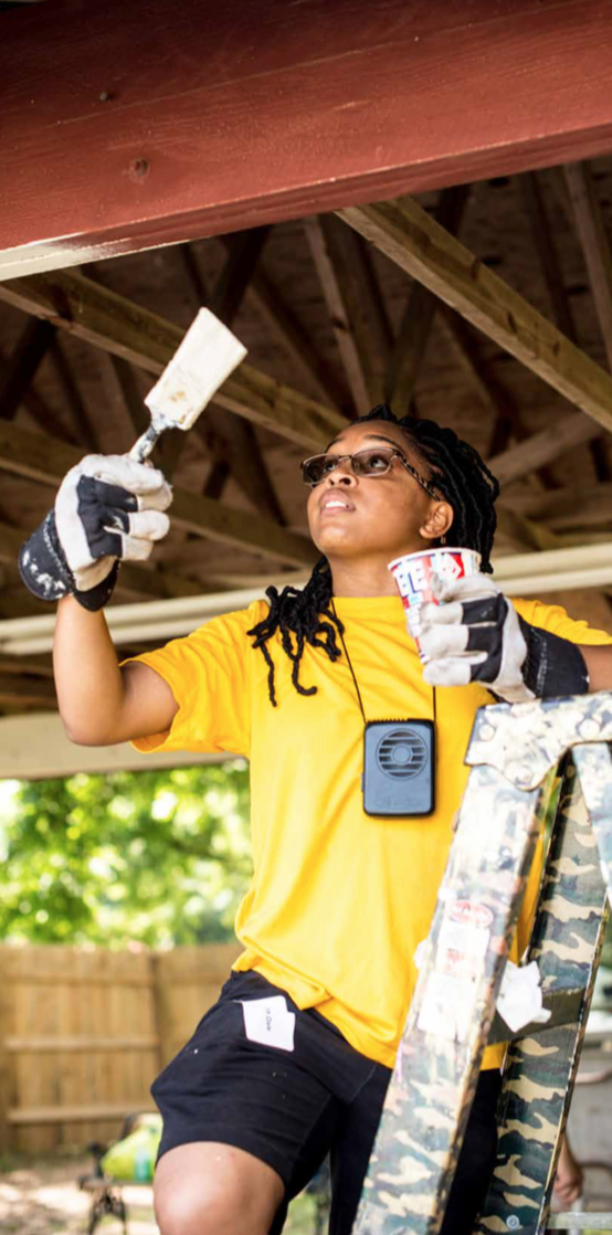 Protective Life volunteer working at one of Project Horseshoe Farm's Ladies Houses