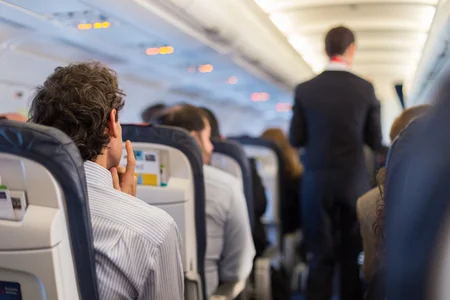 53586633_S_flying_airplane_passengers_man_sitting.jpg