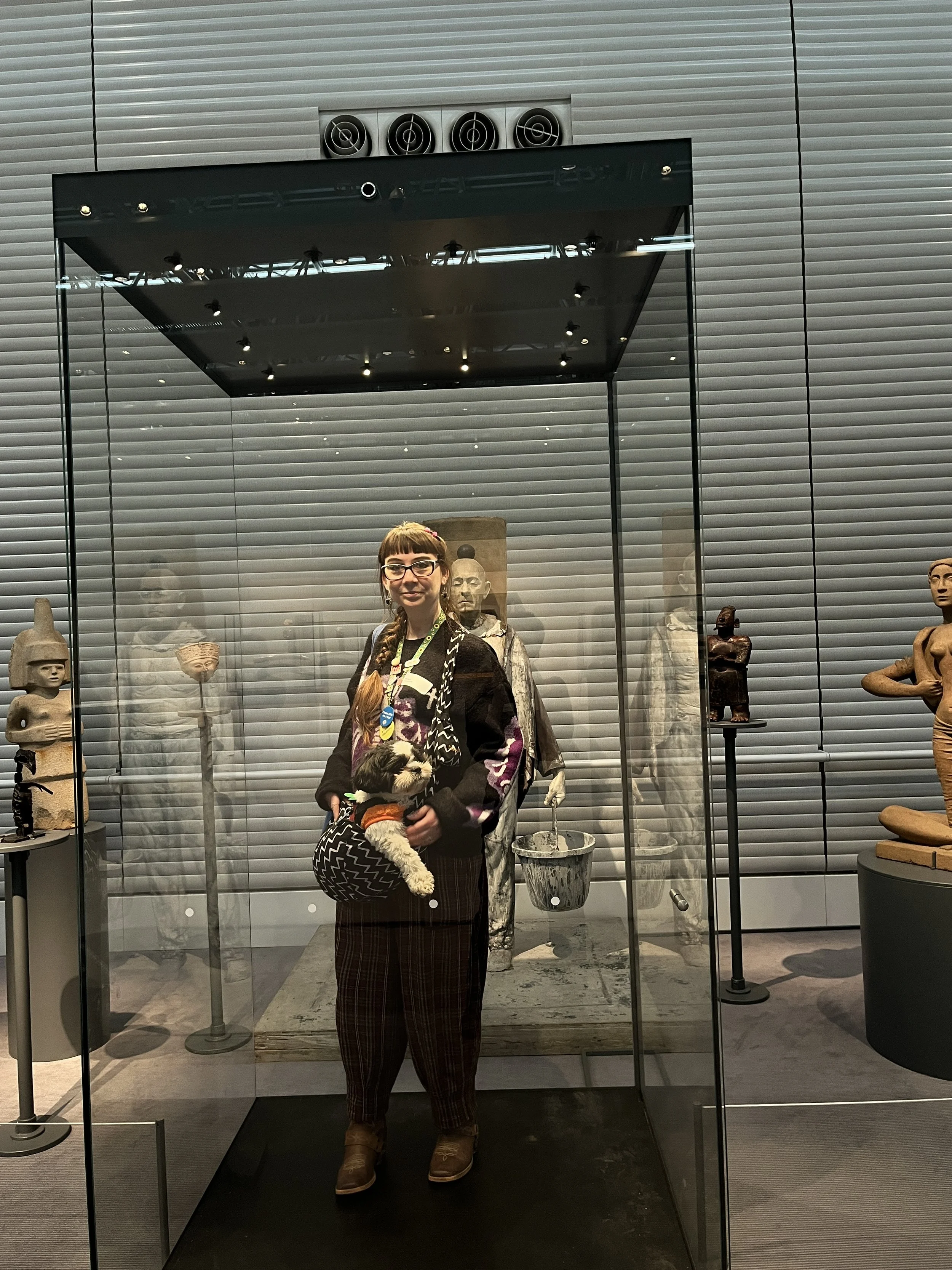 Anna with Parsley the dog in a glass box