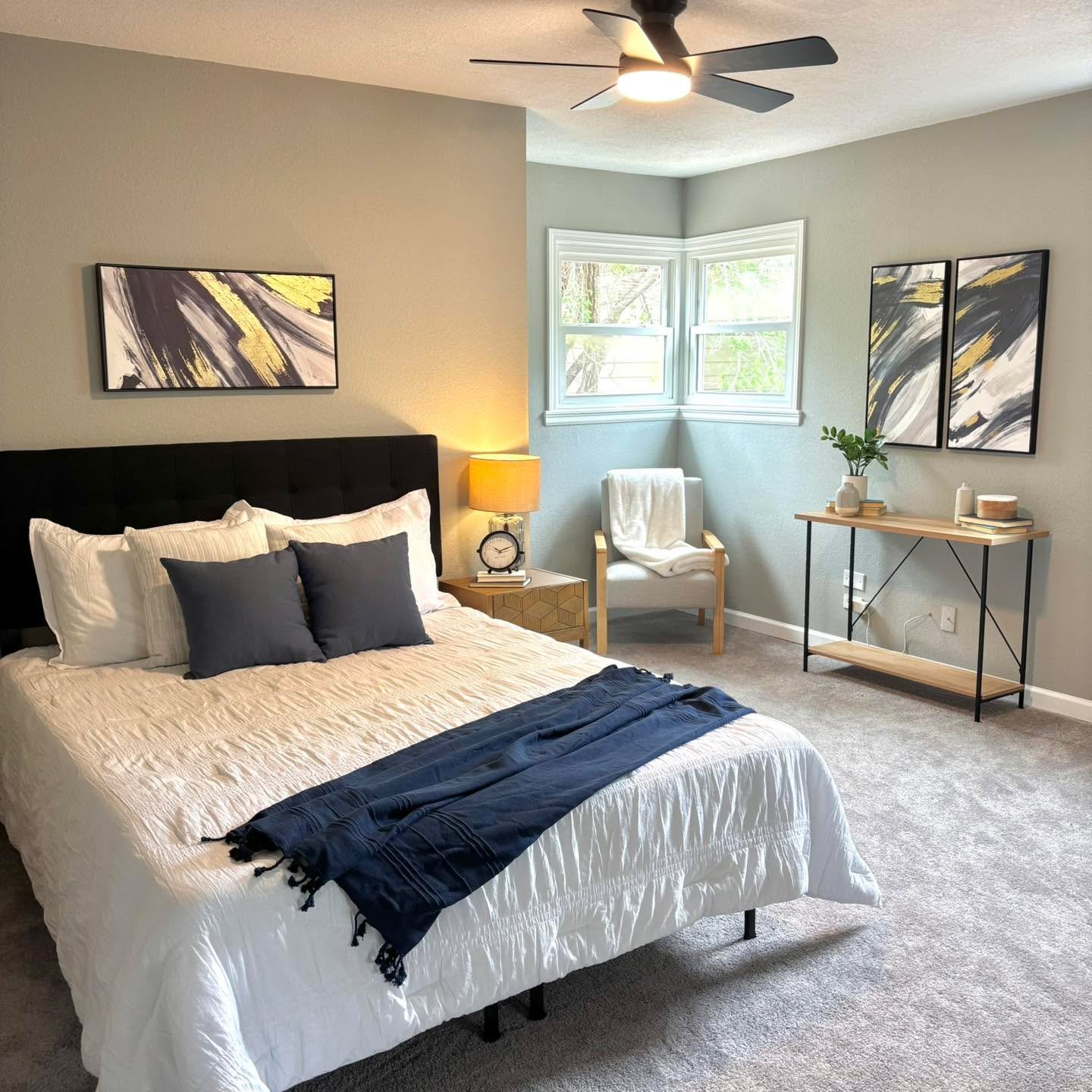 Soft neutrals, layered textures, and just the right touch of contrast ✨ This staged bedroom was designed to feel calm, elevated, and move-in ready. The cozy seating nook, modern artwork, and crisp bedding create a space that feels both spacious and i
