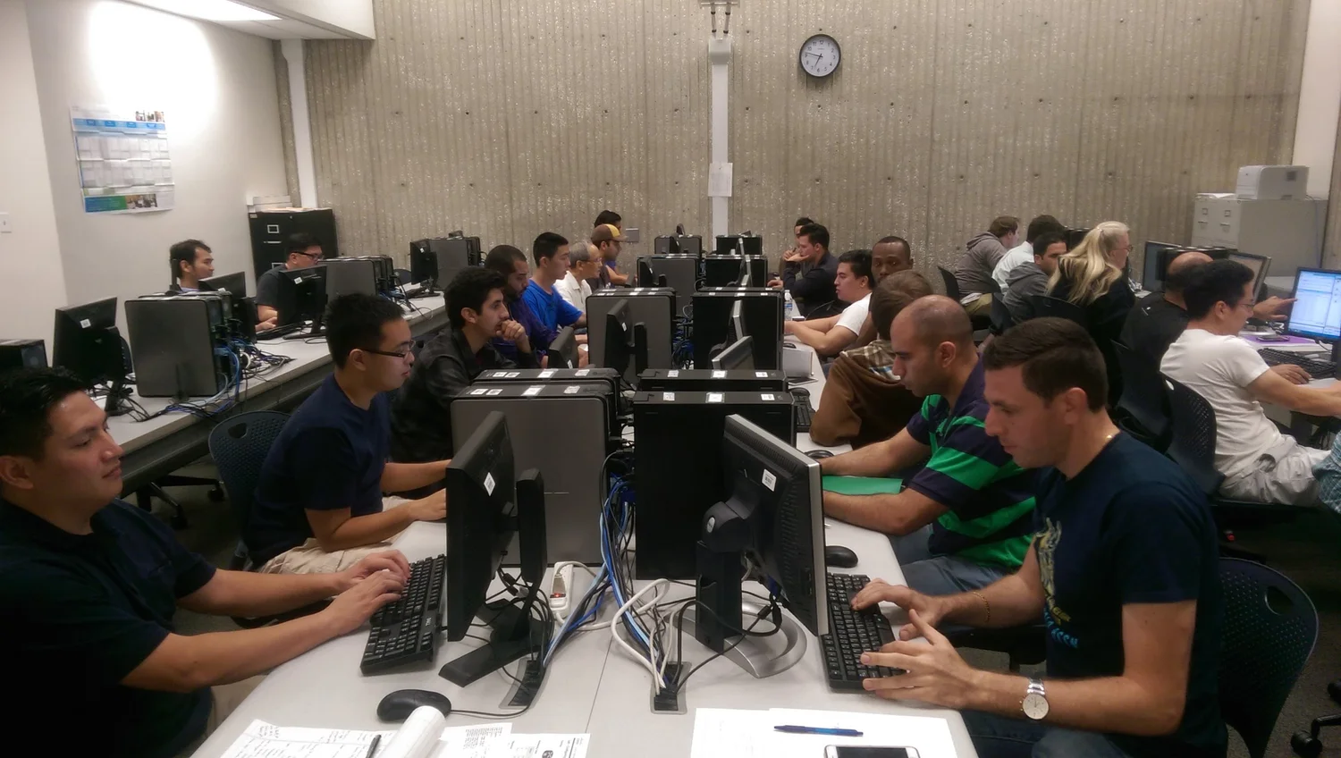 Instructors working through hands-on networking labs at a WASTC training session