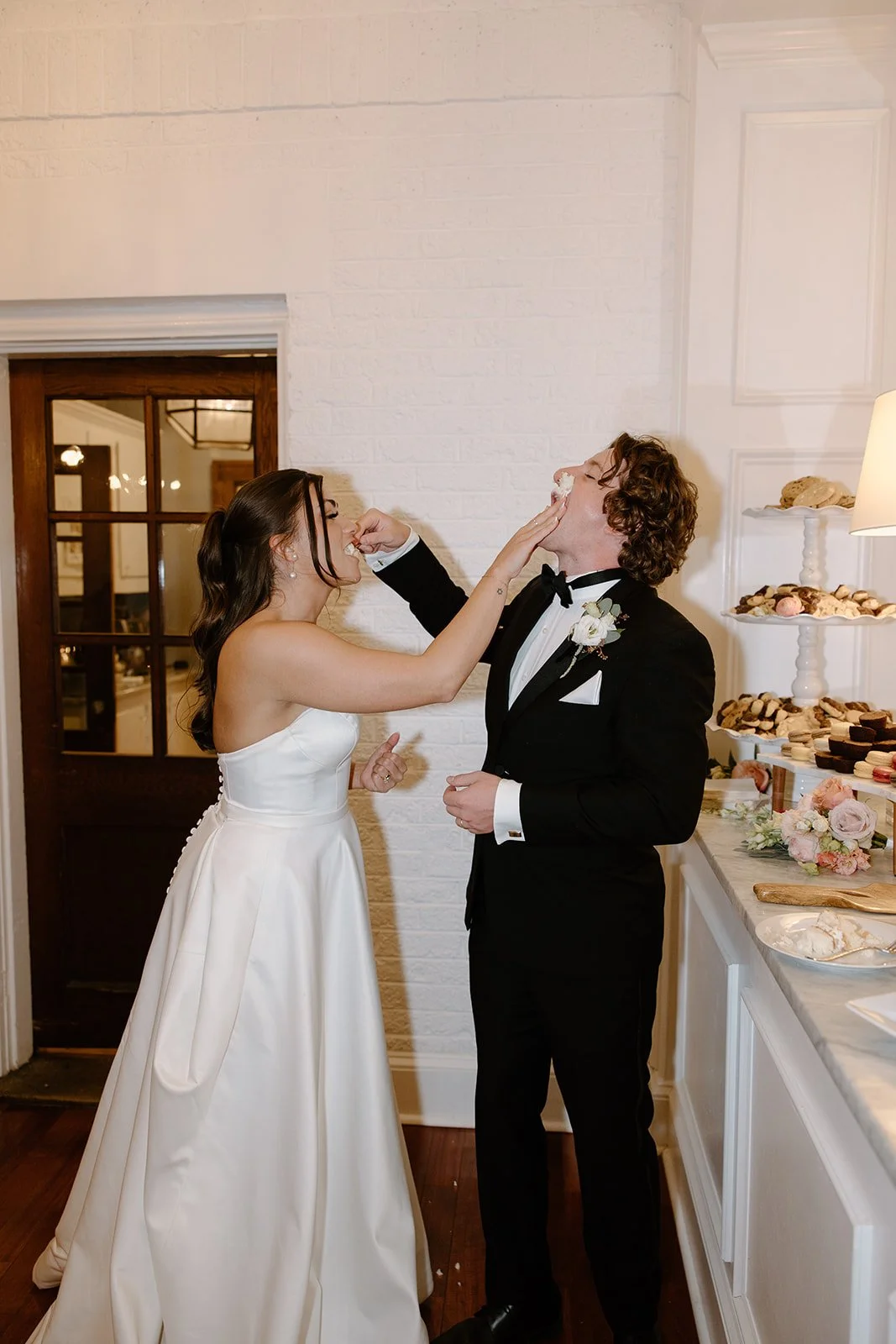 Bride and groom feeding each other cake during their wedding reception.