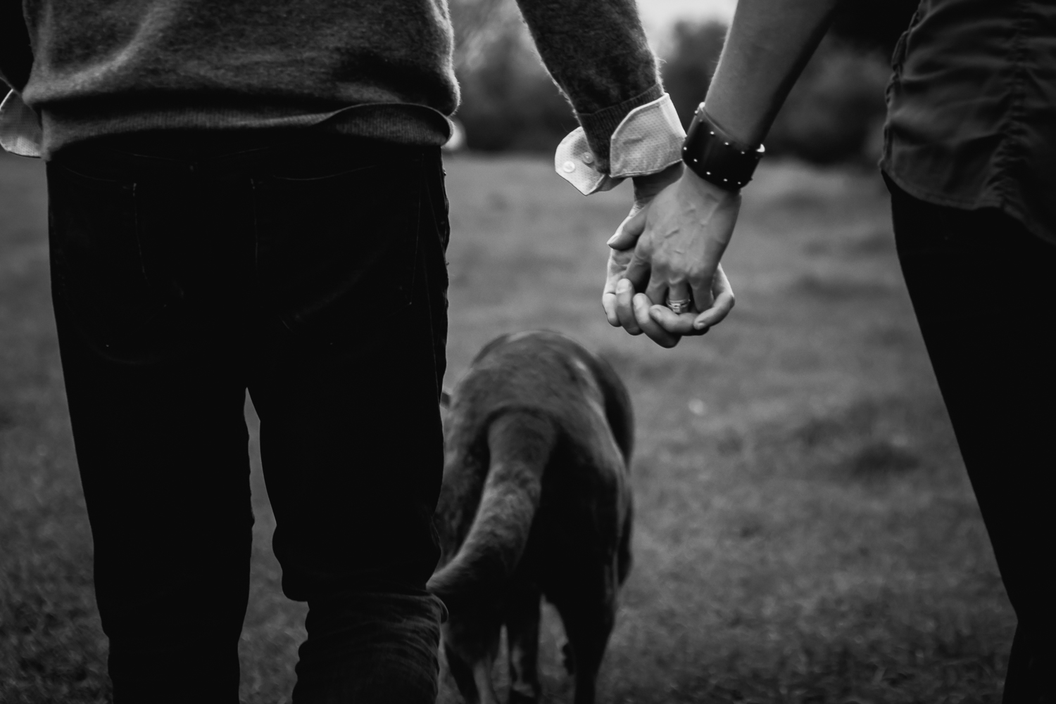 Holding hands during a couples shoot in black and white