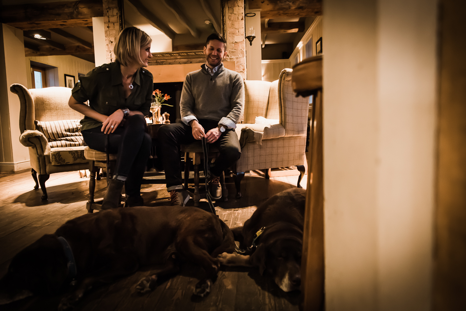  couple laughing together and dogs sleeping in the pub 