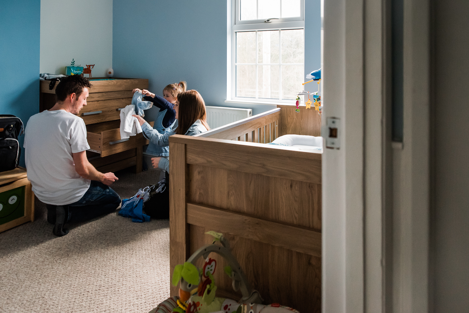 Family in the baby nursery