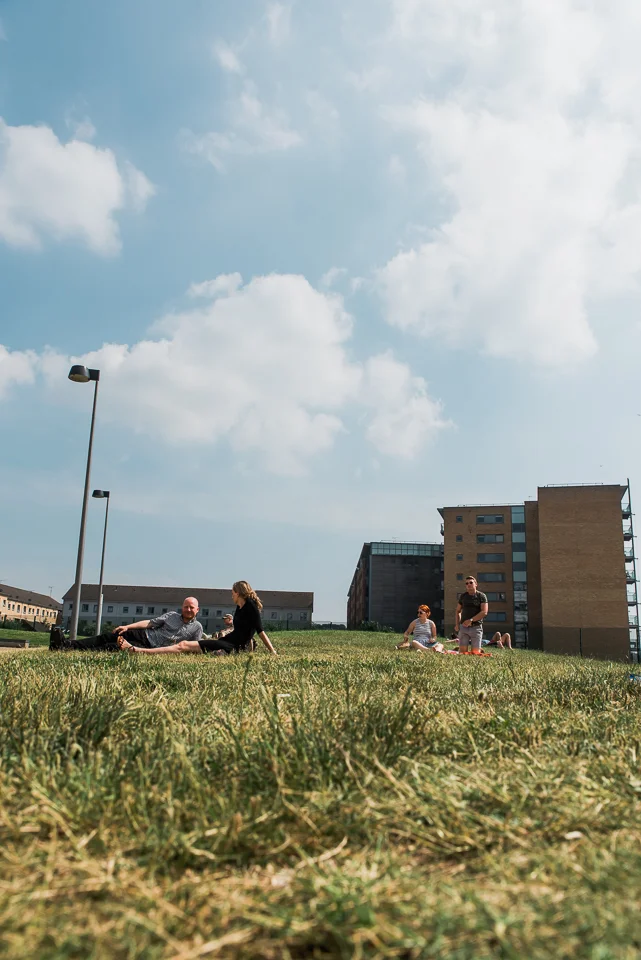People chilling on the lawn on a sunny day by Ipswich waterfront