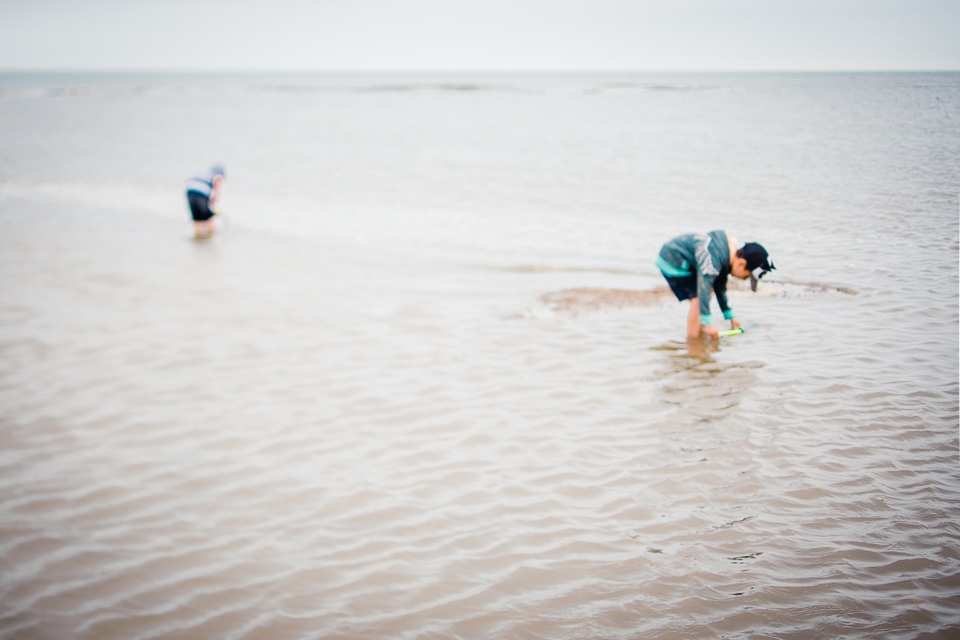 Two children having a dip in the sea in North Norfolk