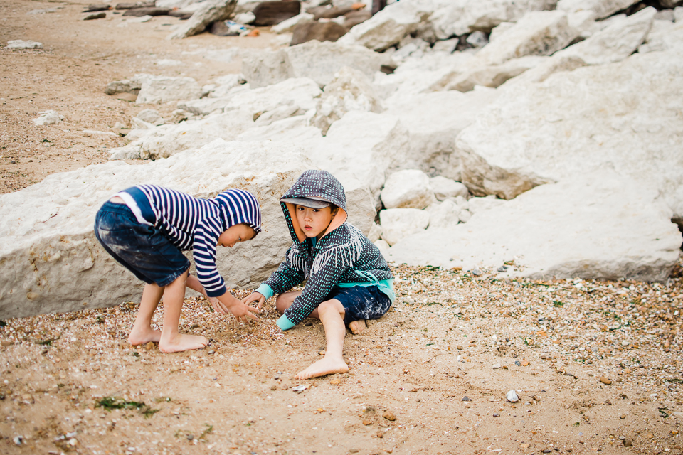 Two children playing by the cliffs at Hunstanton beach