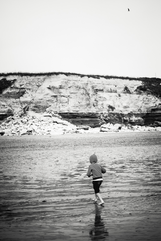 Black and white photograph of Hunstanton cliffs with boy on the 