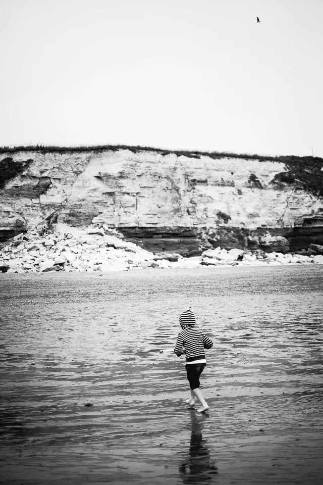 Black and white photograph of Hunstanton cliffs with boy on the