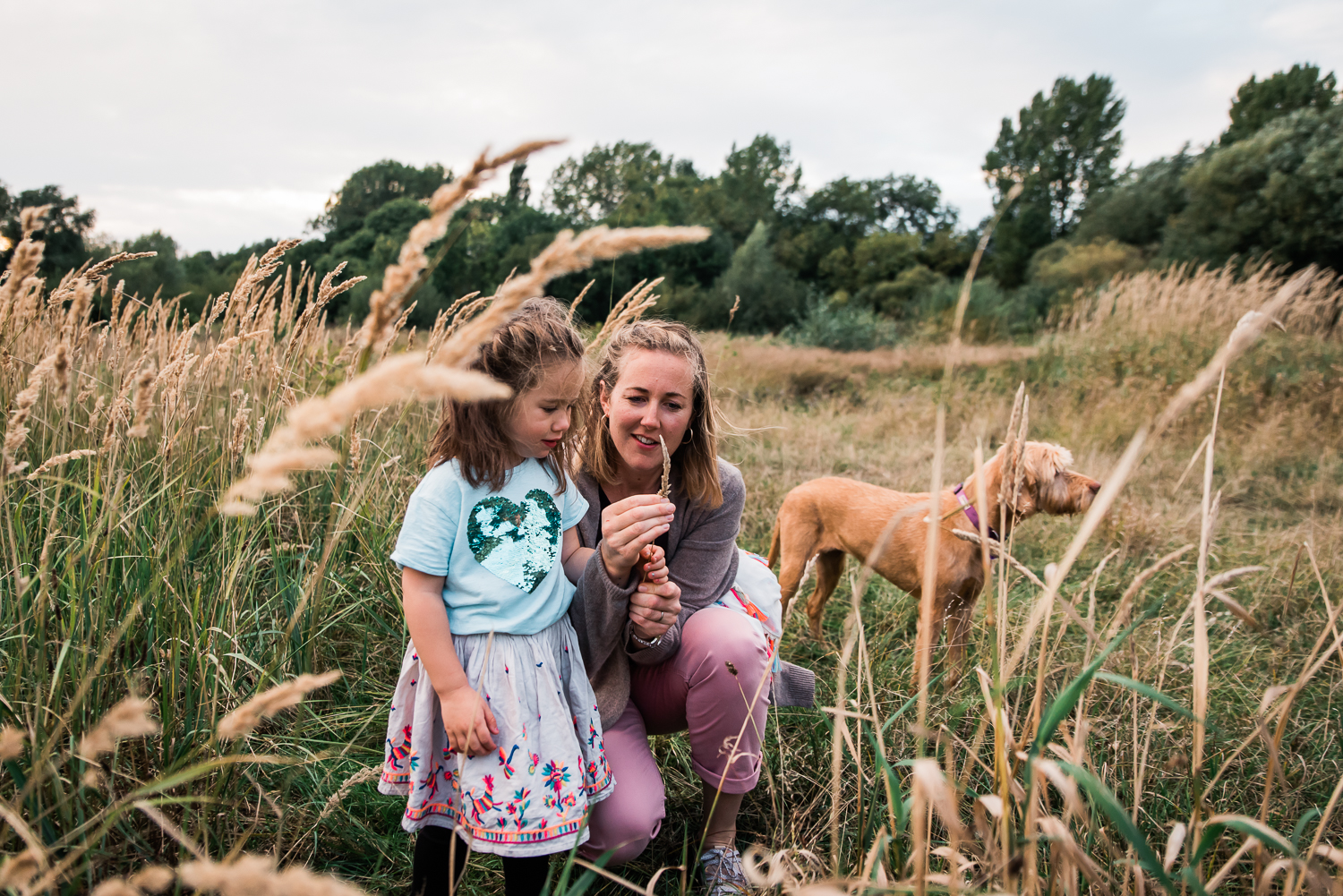 Mother and daughter amongst the tall grass at Hinchingbrooke Cou