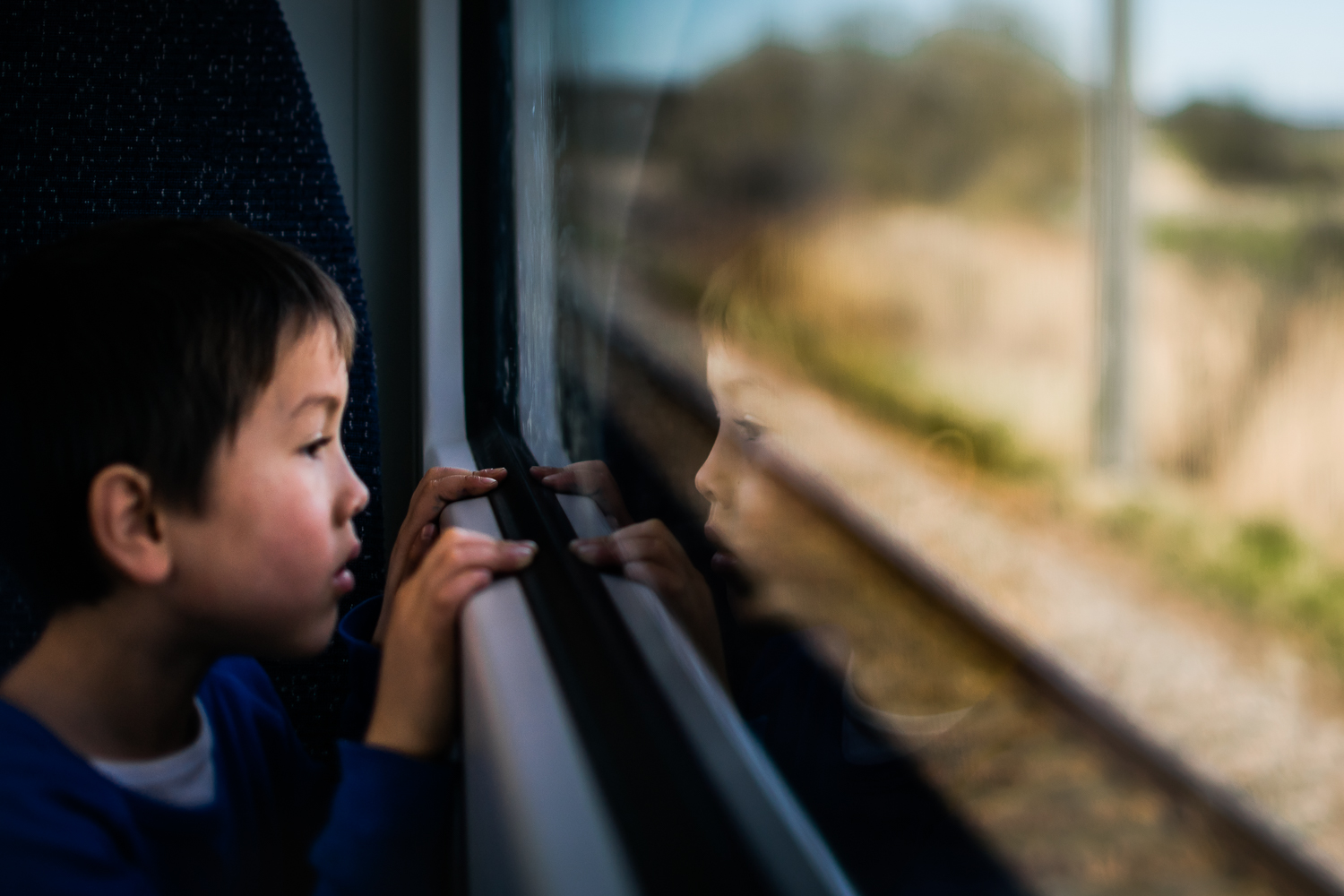 Freelensed photograph of boy on a train