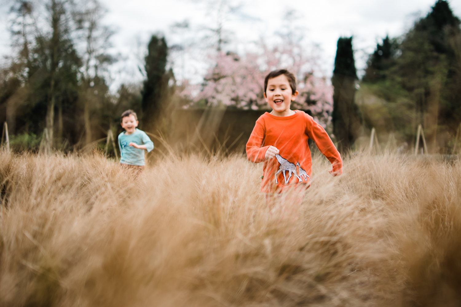 Children running through a grassy field
