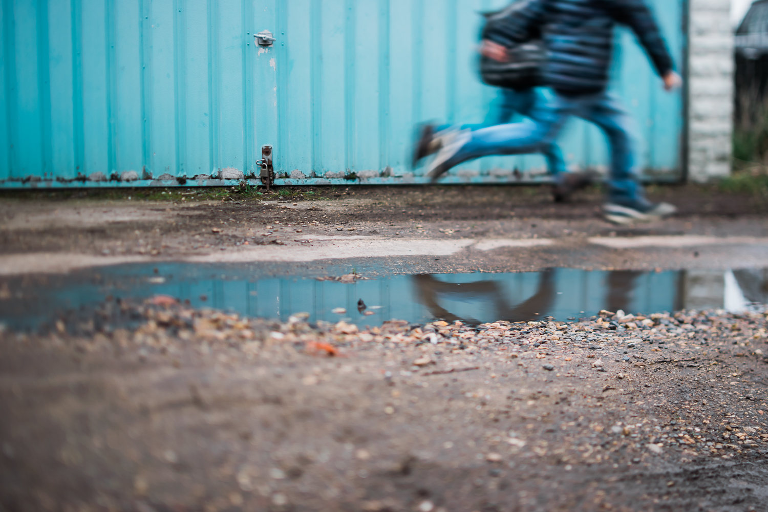 Freelensed photograph of boys running and their reflection blue 