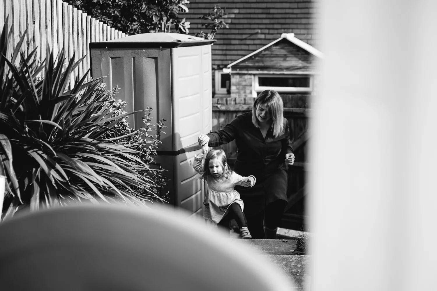 Mum and daughter walking around in the garden