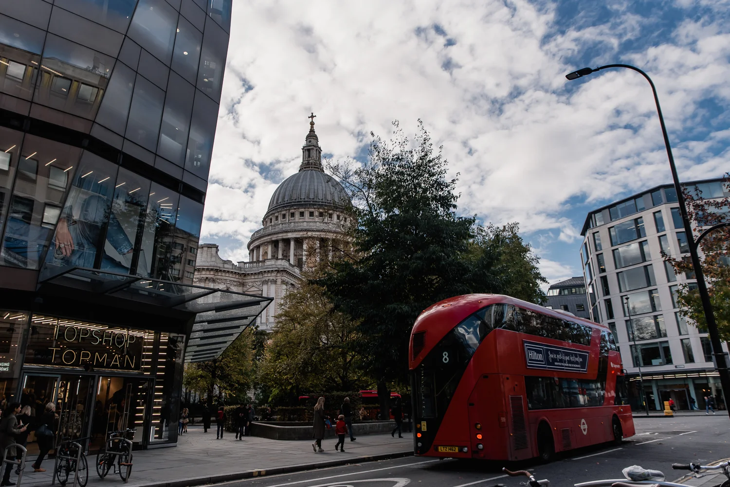 St Paul's cathedral at street level with a London red bus in the