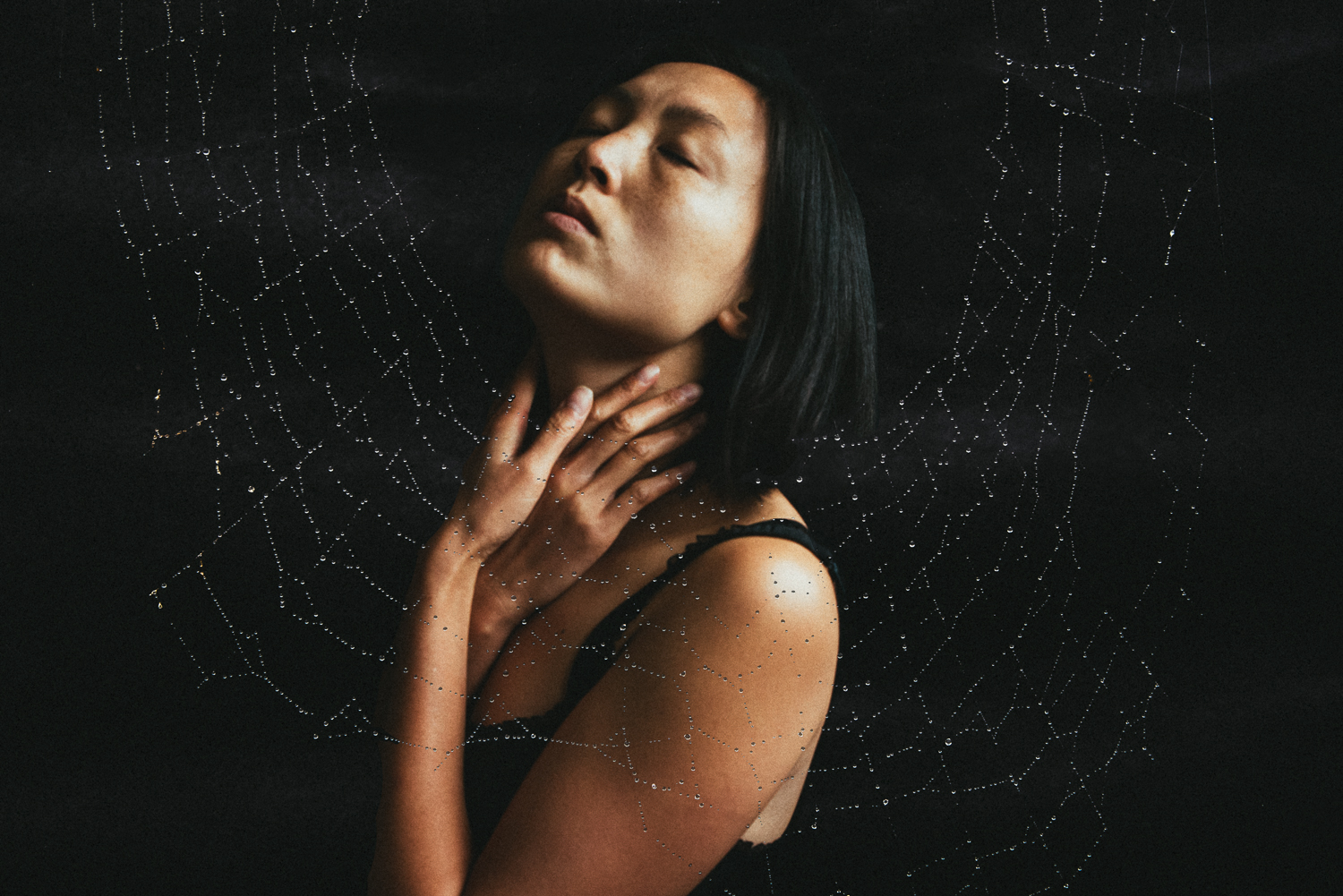 Double exposure self-portrait with a spider web