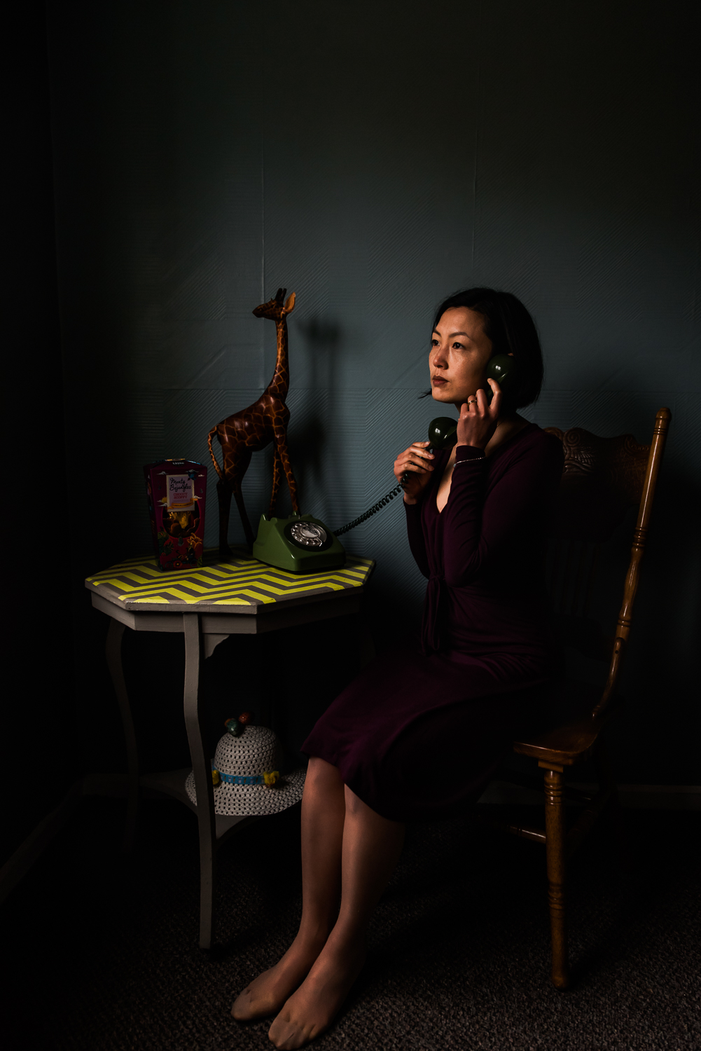 Photographer sits with her telephone in her hands surrounded by 