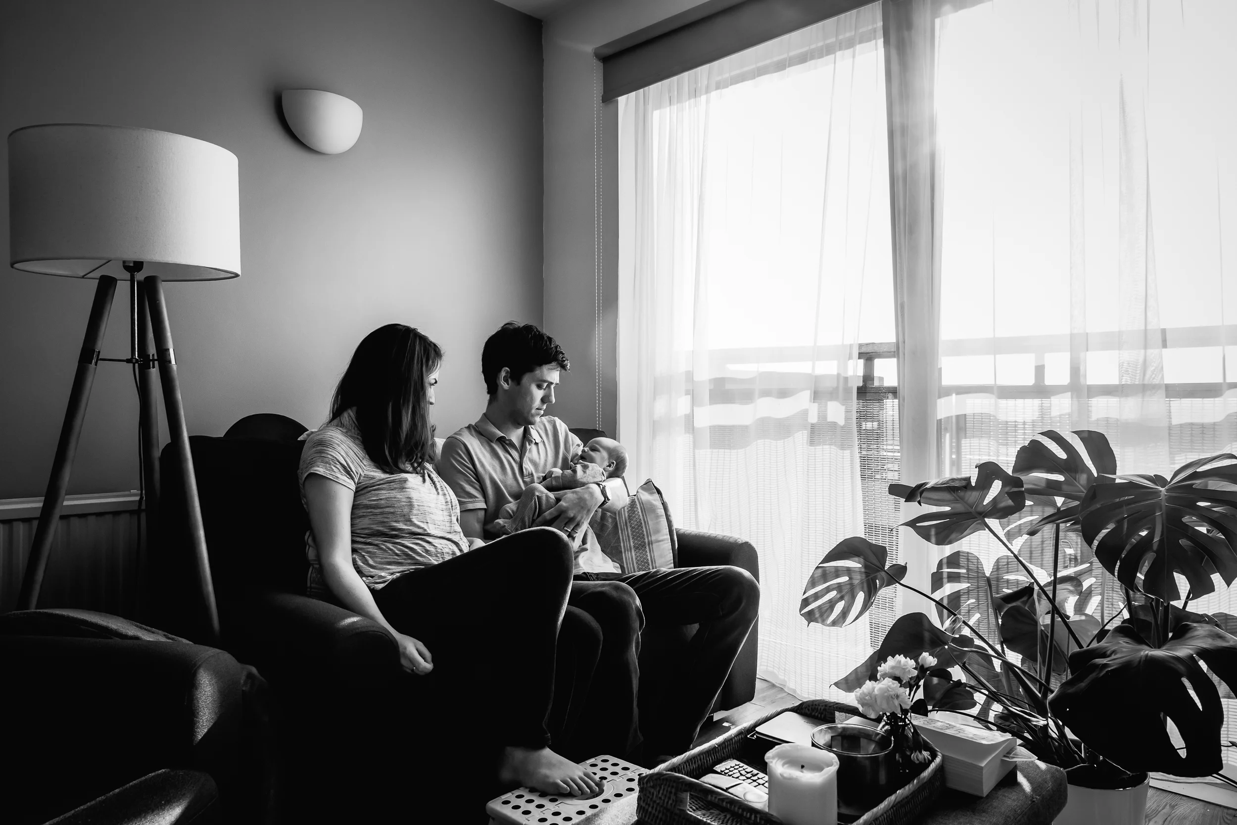 Black and white photograph of two parents with their baby in the