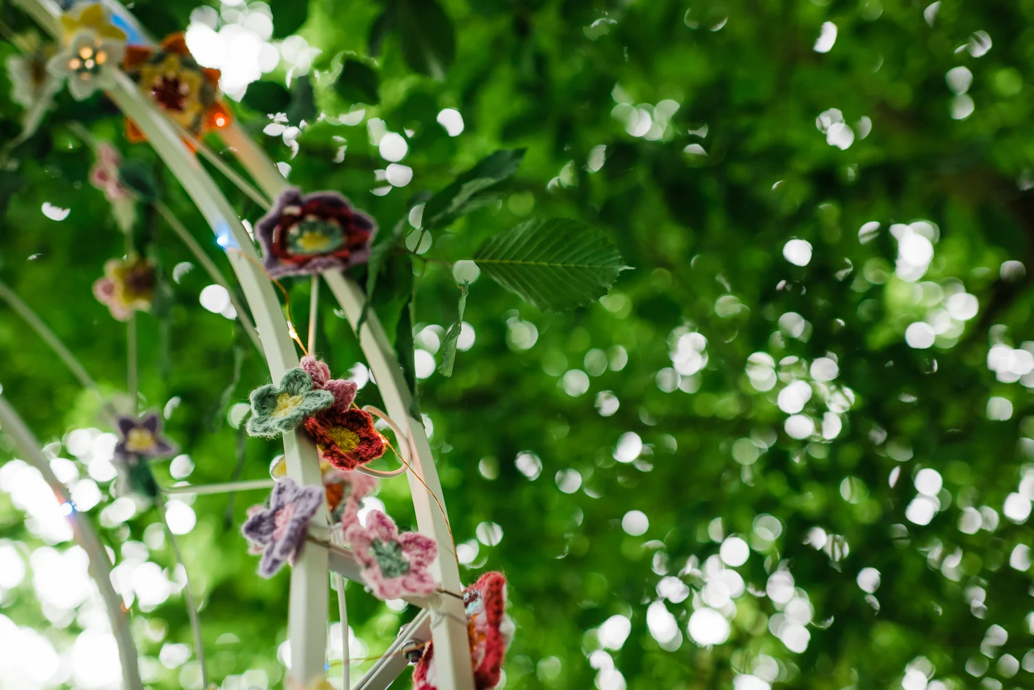 Crochet flower decorations on a wedding arch