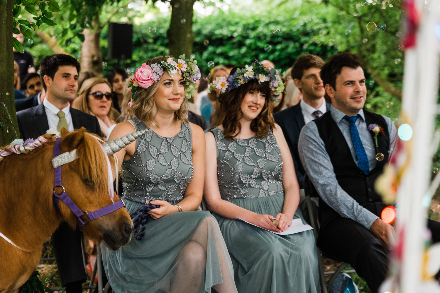 Wedding guests at an outdoor wedding ceremony in a Cambridgeshir