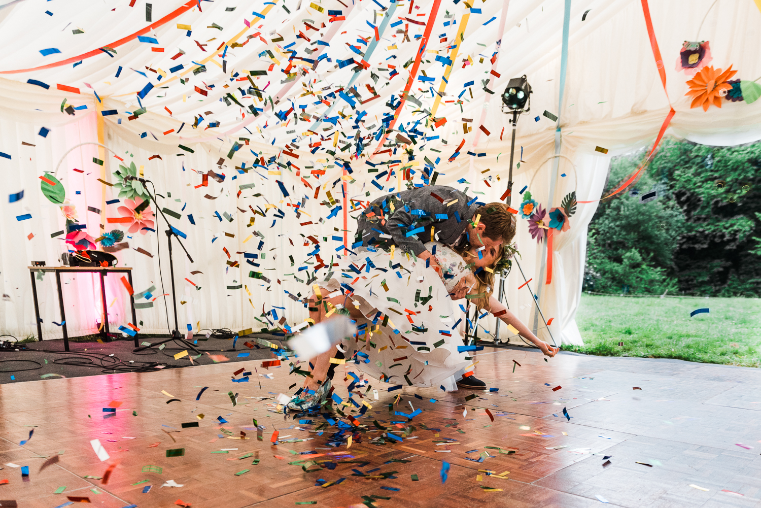 Bride and groom on the dancefloor under a shower of colourful co