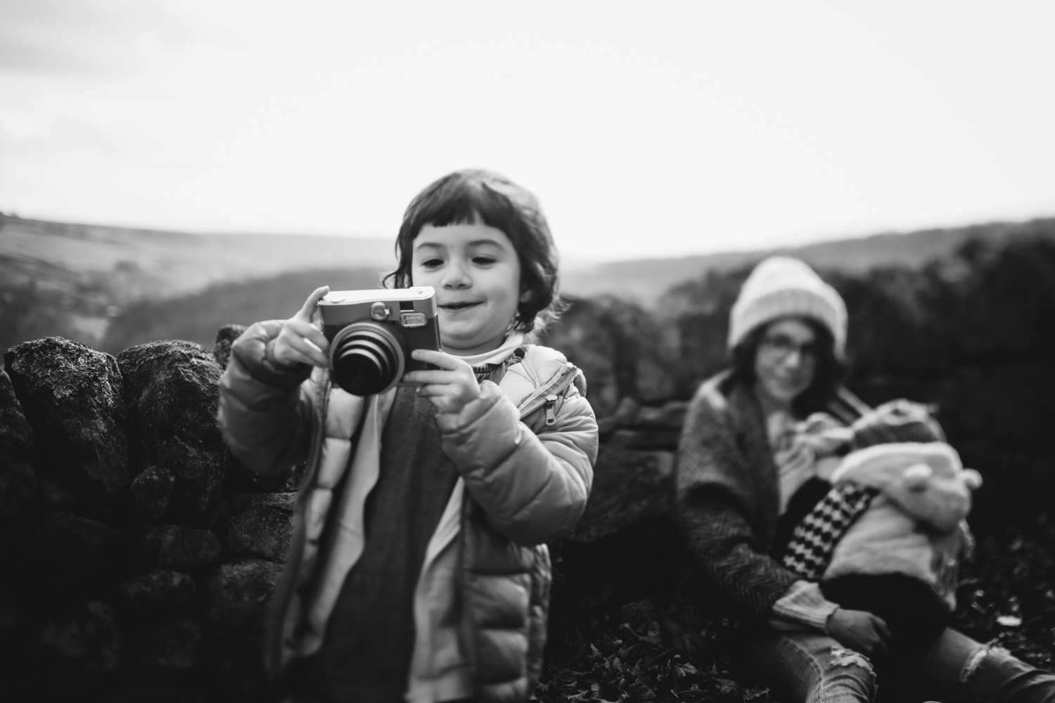 Copy of Black and white photograph of child holding onto an instamatix c