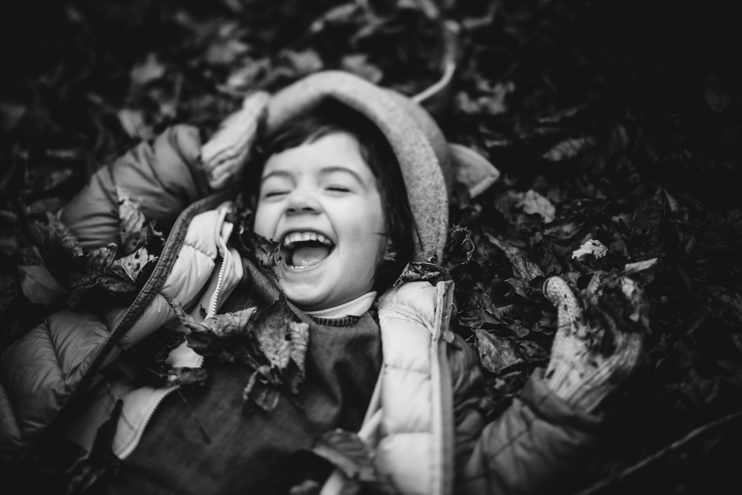 Copy of Black and white freelensed portrait of a little girl rolling aro