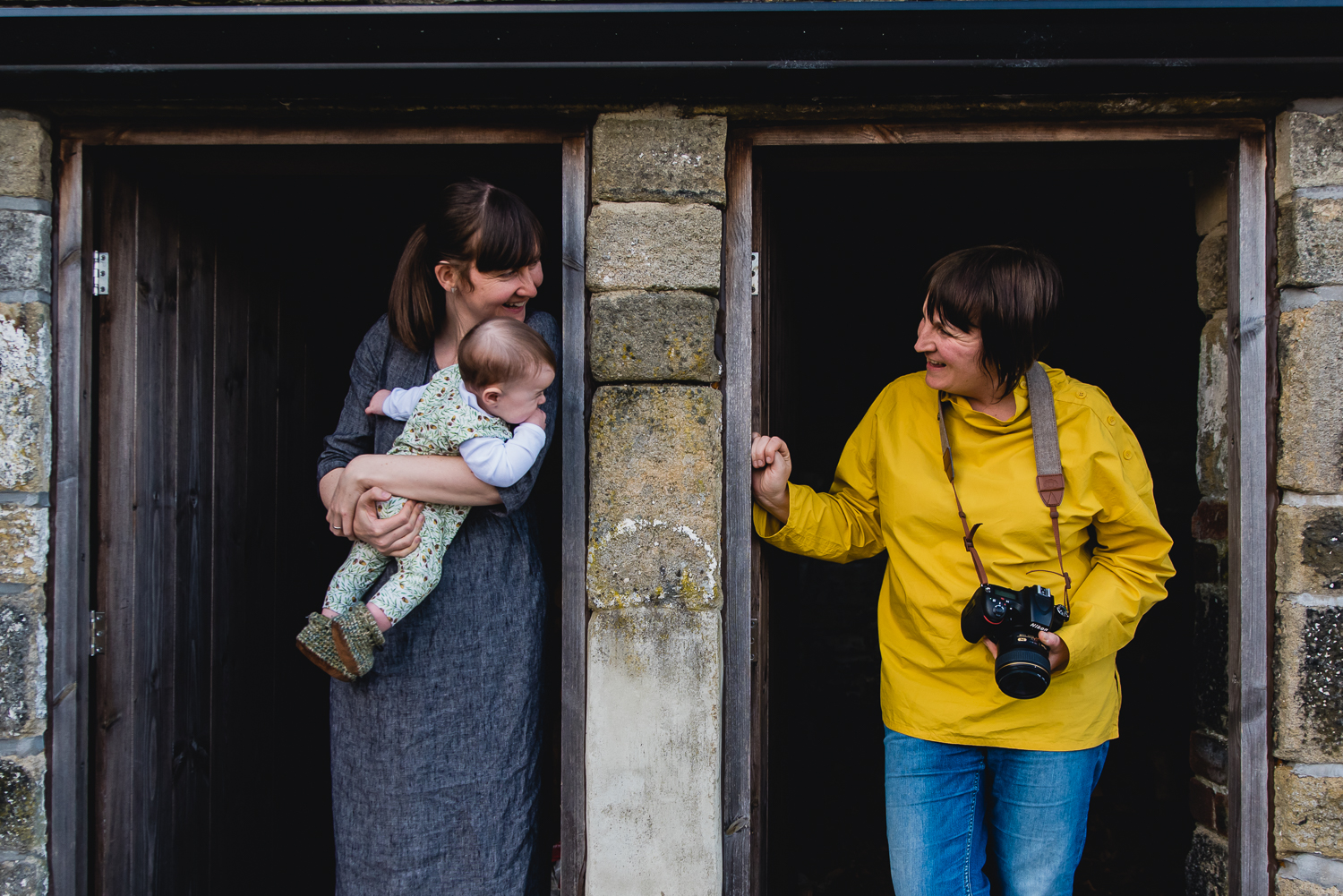 Family photograph of a same-sex couple and their baby inside a b