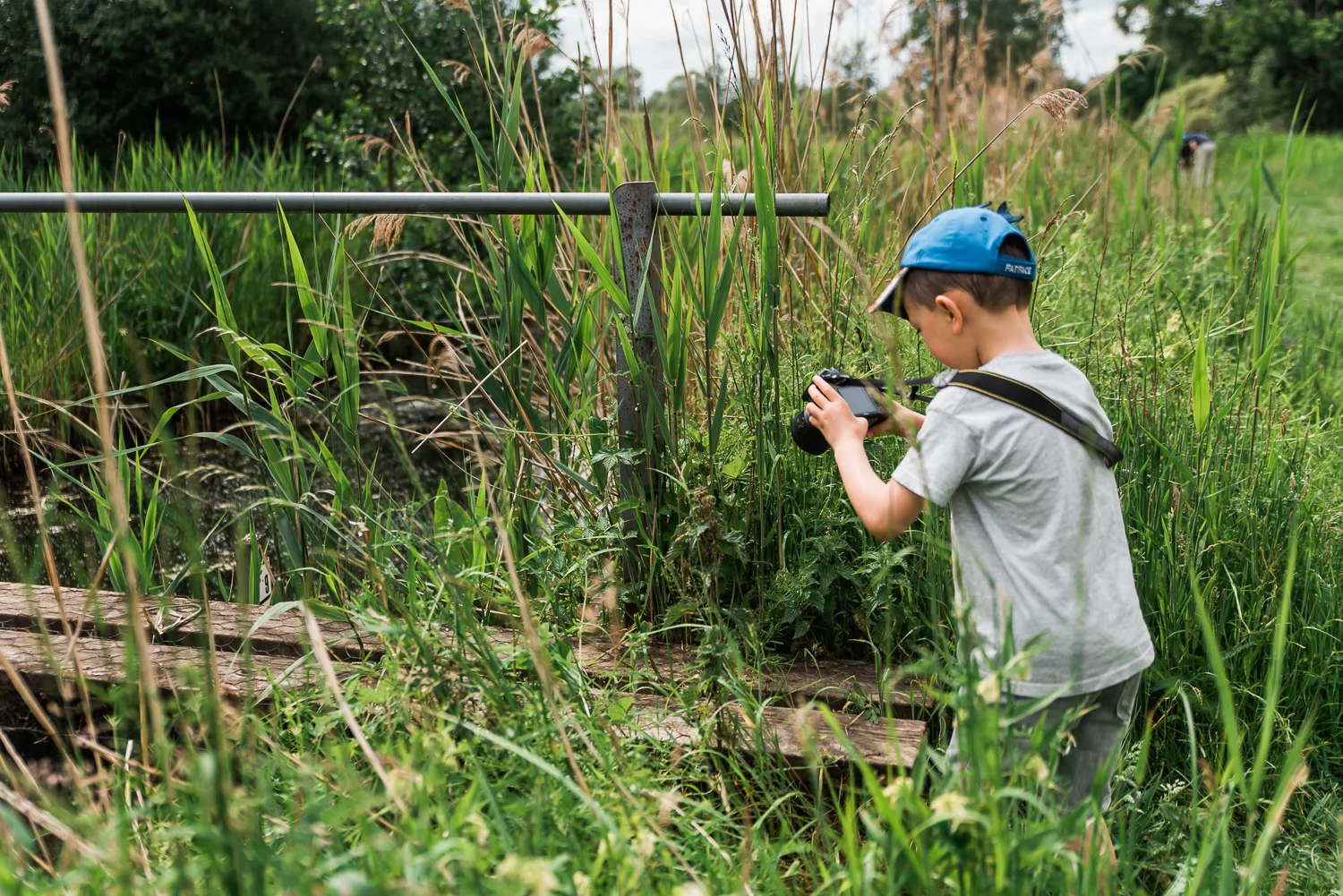 Family out exploring Woodwalton Fen in the summer by Cambridgesh