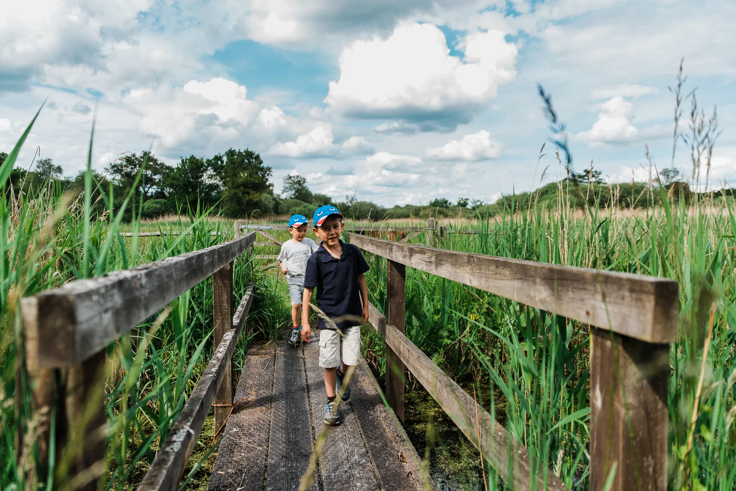 Family out exploring Woodwalton Fen in the summer by Cambridgesh