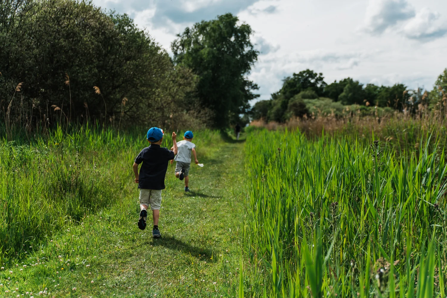 Family out exploring Woodwalton Fen in the summer by Cambridgesh