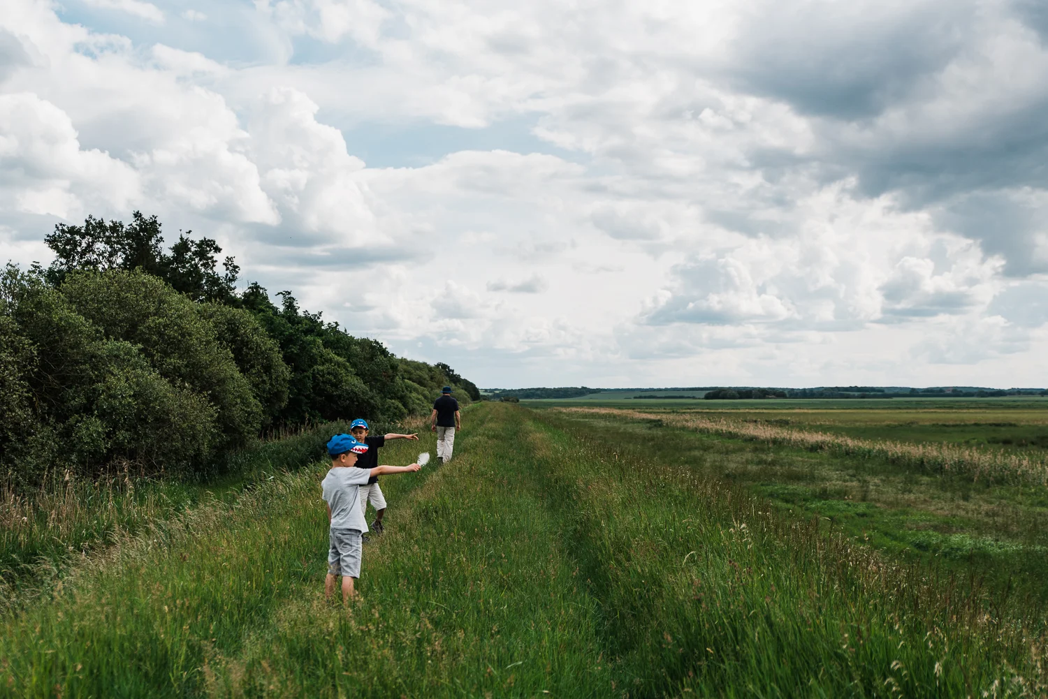 Family out exploring Woodwalton Fen in the summer by Cambridgesh
