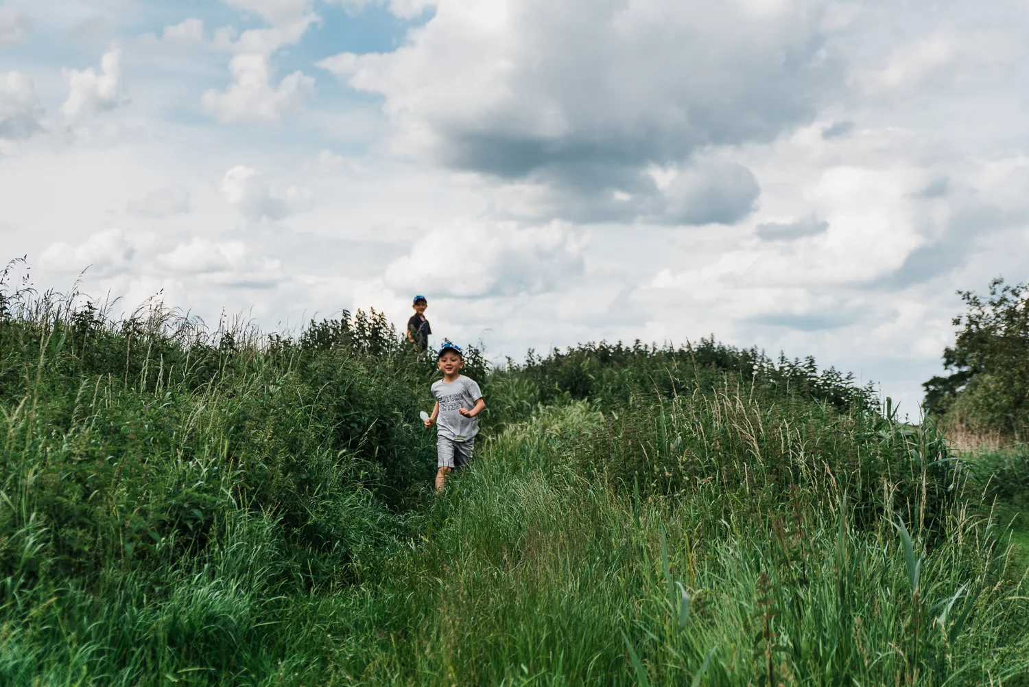 Family out exploring Woodwalton Fen in the summer by Cambridgesh