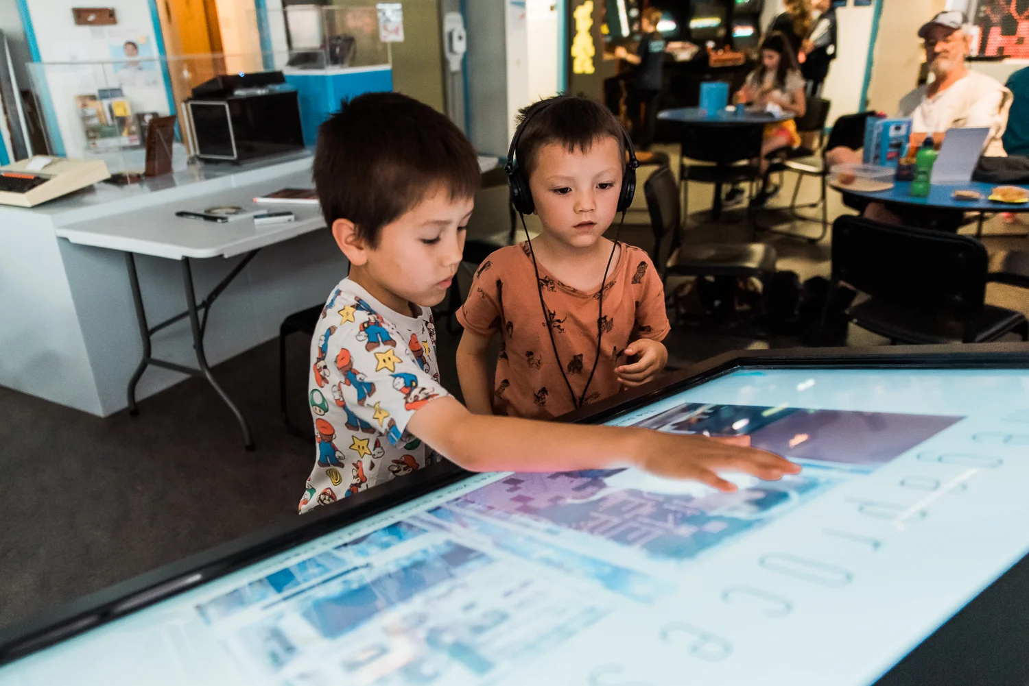 Two children working the touchscreen displays in the Museum of Computing History in Cambridge
