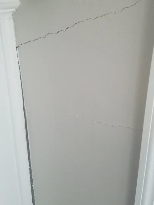 interior wall crack and mantel pulling from the wall