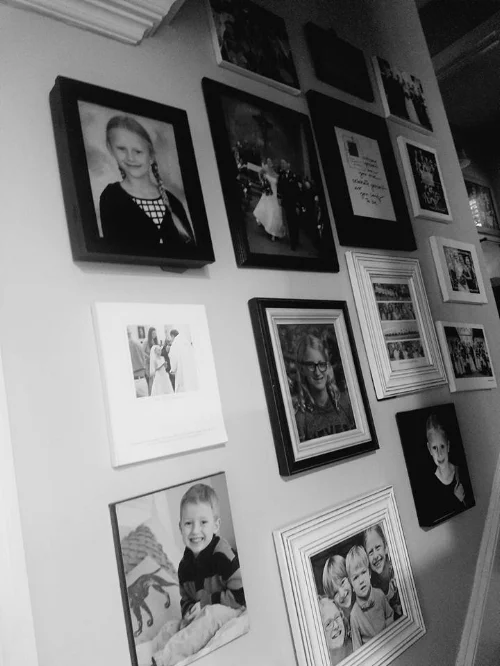 This is a stair gallery in our house. Hard to grab a photo of this, but the angle of the bottom pictures is going along the stair line. Everything is in a white or black frame to give balance. Objects that are not framed are balanced with those that are. 