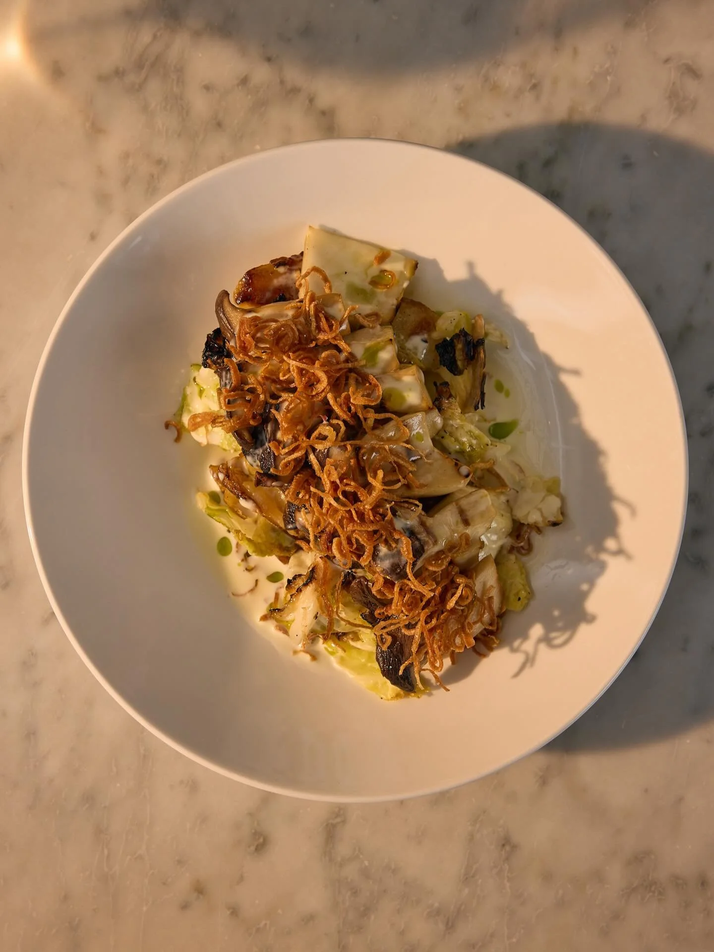 BACK AT IT THIS WEEK

and a great dish to talk about in the new year is a staff + guest favorite from our autumn/winter menu: grilled trumpet mushrooms (gf). 

salt roasted potatoes and crisp cabbage get saut&eacute;ed, crisped + hard seared, with te