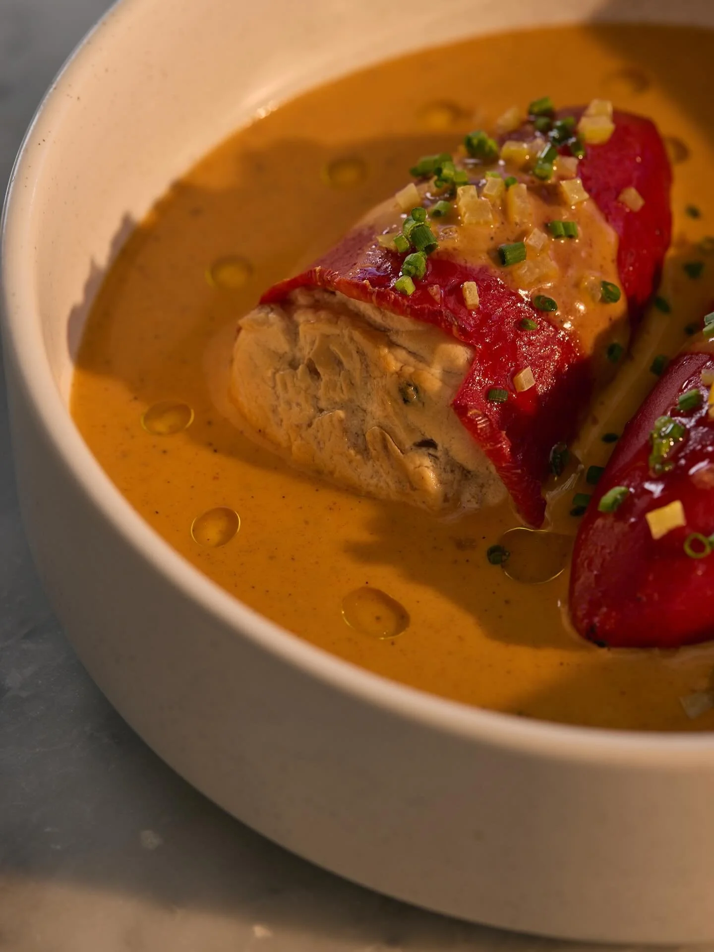 stuffed piquillo peppers (v+, gf) 

these sweet little spanish red peppers are filled with a mixture of farmers cheese called quark + caramelized onions, topped with preserved lemon, chives + swimming in a pool of smoked paprika vinaigrette. our vega