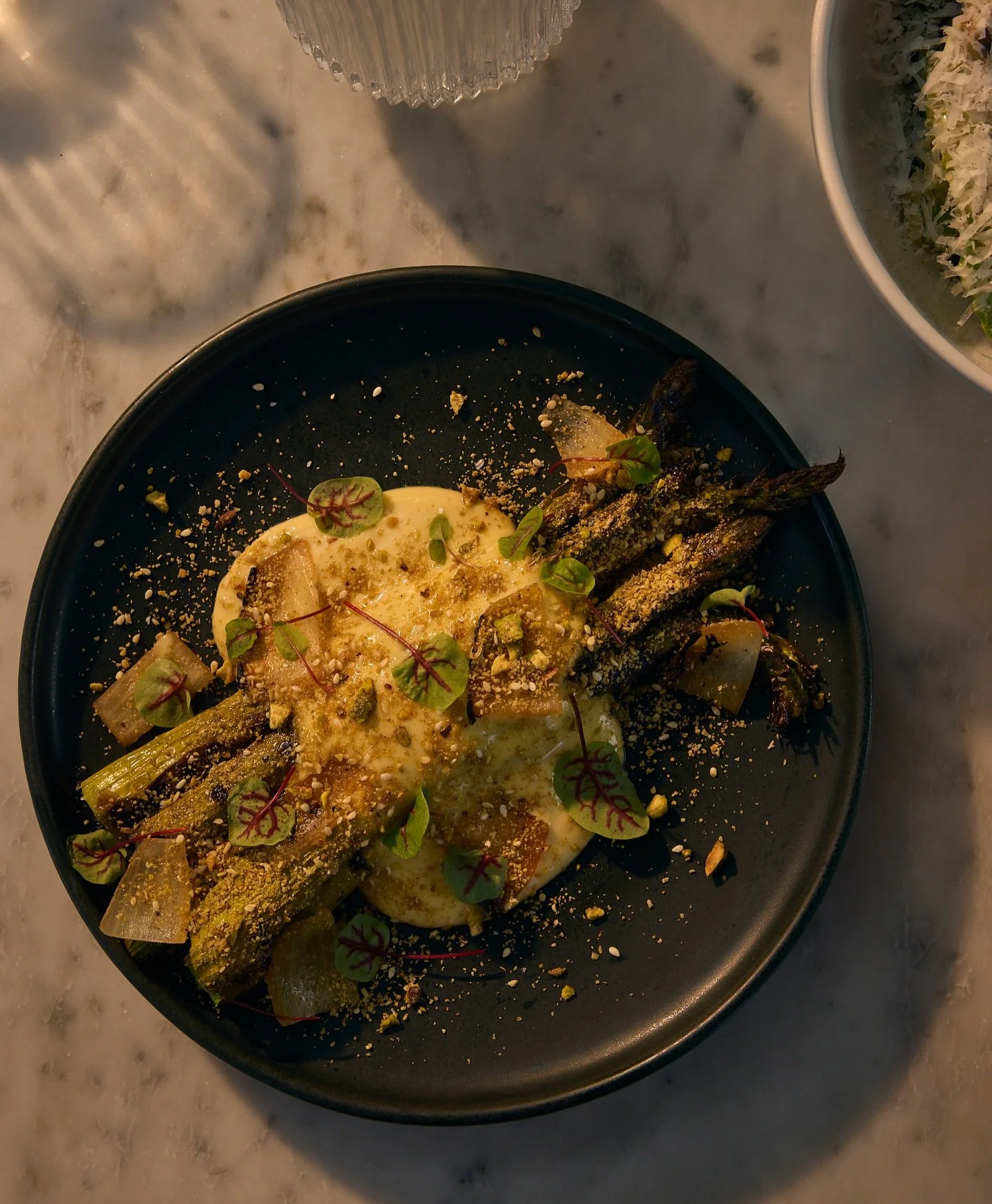 spring time means asparagus, and we&rsquo;ve got the perfect blend: tender, jumbo stalks get grilled, seasoned, and served along side a classic pairing of velvety vegan saffron hollandaise, blistered onion petals + a crunchy pistachio dukkah finishin