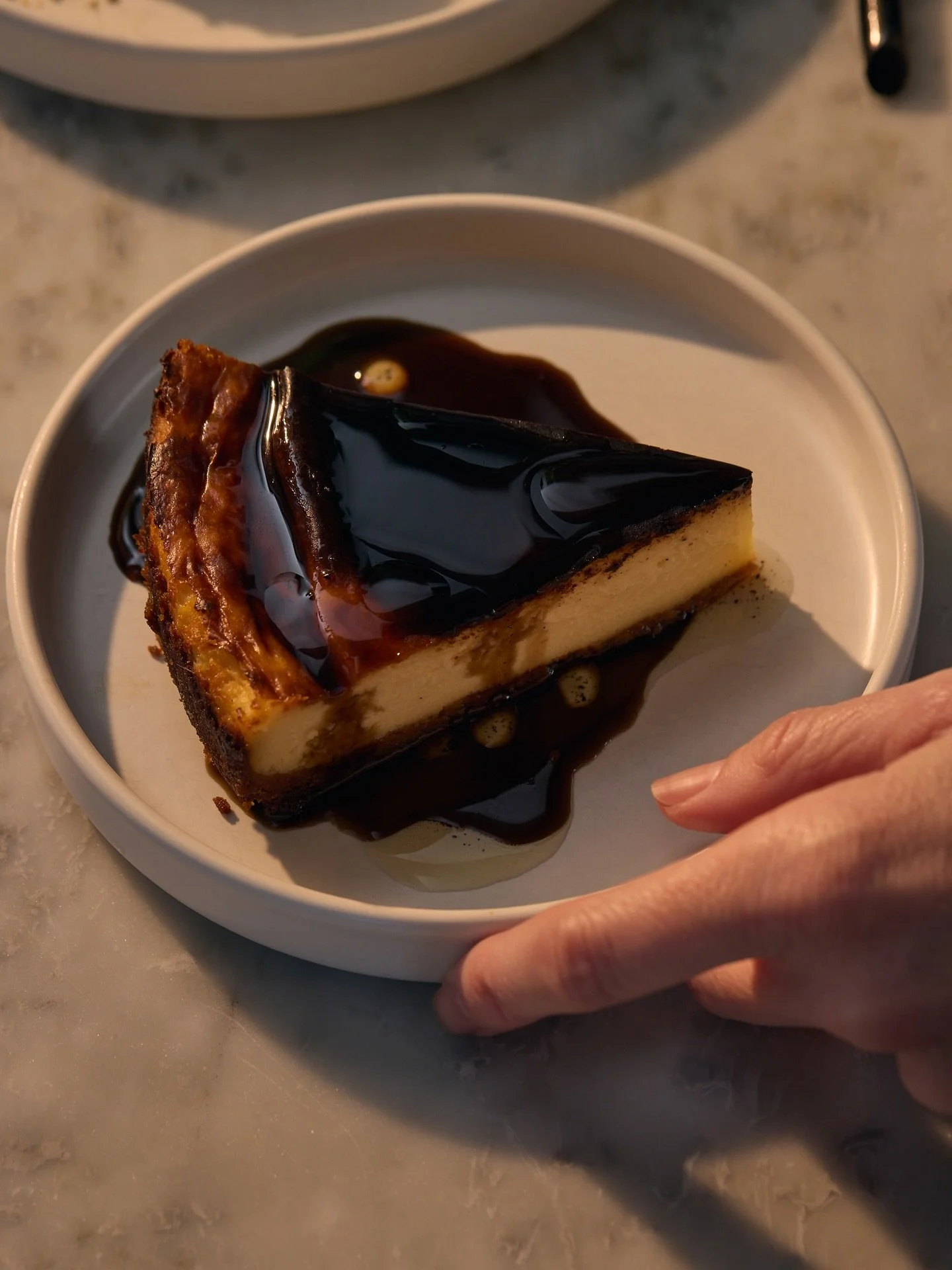 our nocino cheesecake: like new york + basque styles had a baby, with a graham cracker crust, @watersheddistillery nocino syrup and toasted vanilla oil. sleeper hit of our desserts this season, don&rsquo;t snooze on it!