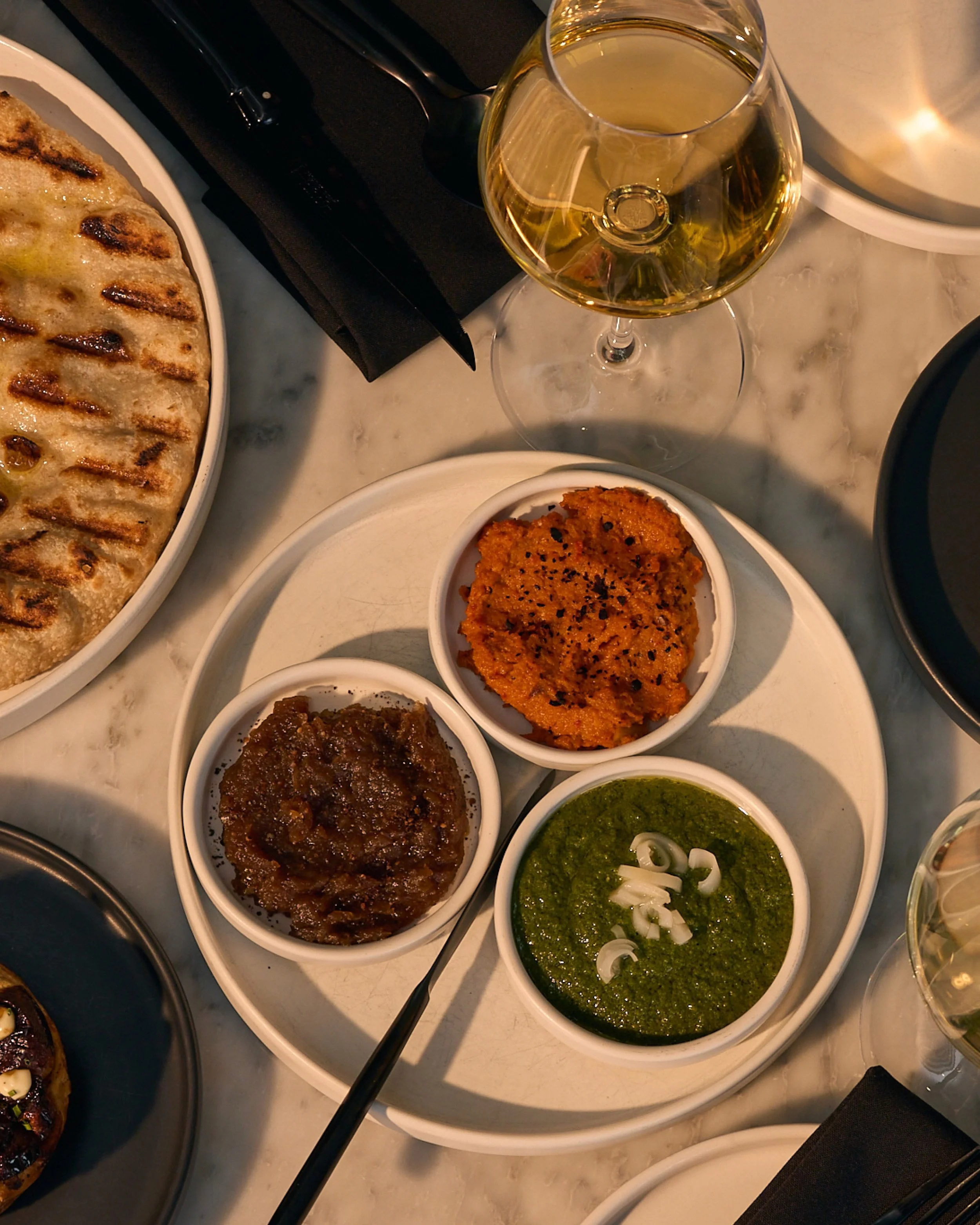 this season&rsquo;s spreads hit all the flavor bases: you&rsquo;ve got the sweet + savory onion jam, smoky + roasty carrot romesco, and spicy + herbaceous pickled ramp zhug. little known fact; you can order an extra koji pita for those of you who can