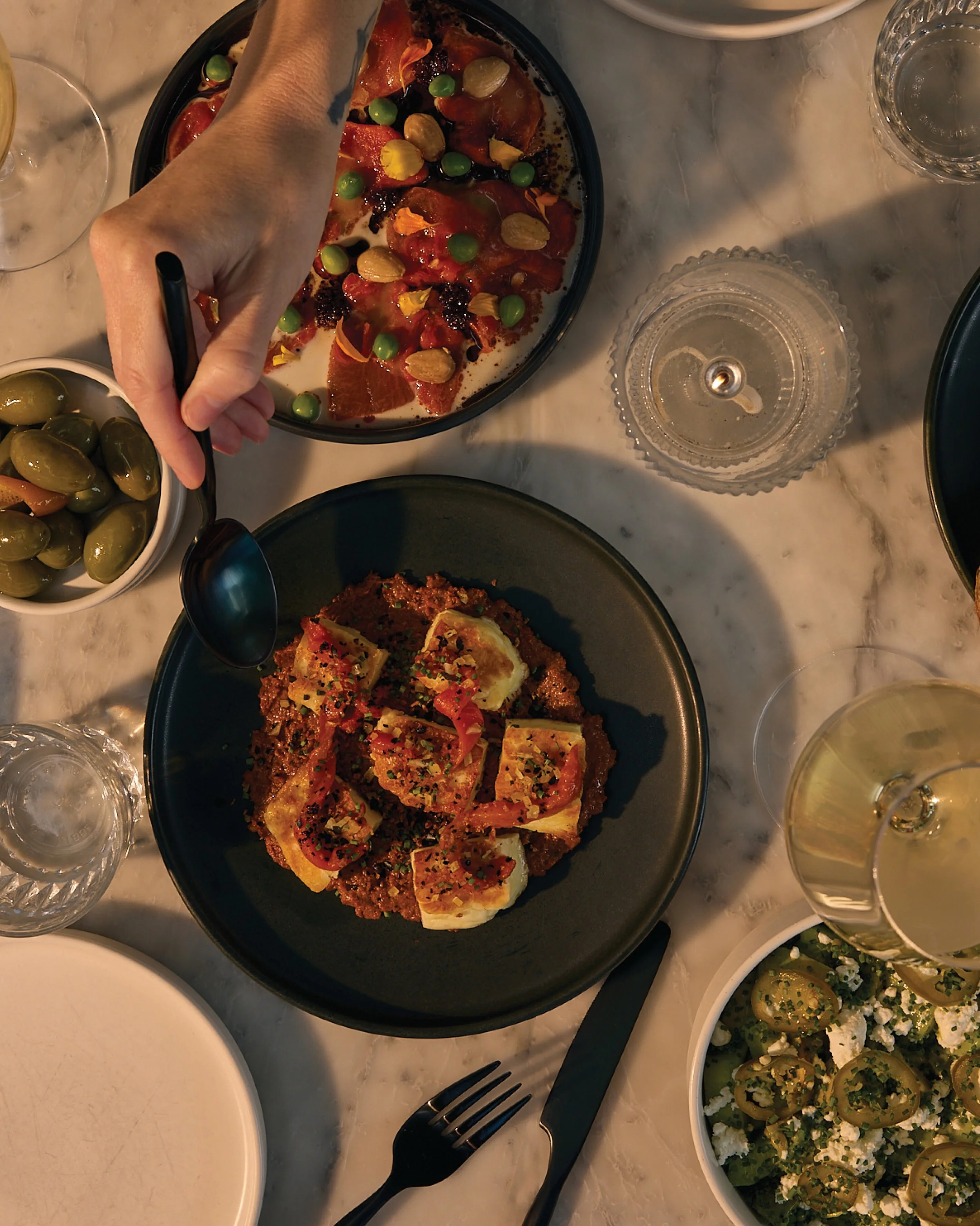 a summer staple at comune. salty, dense, and craveable is how we&rsquo;d best describe our halloumi. seared over the plancha, set up on smoky + slightly sweet muhammara, preserved lemon and a pinch of urfa chile. def one to share, but we wouldn&rsquo