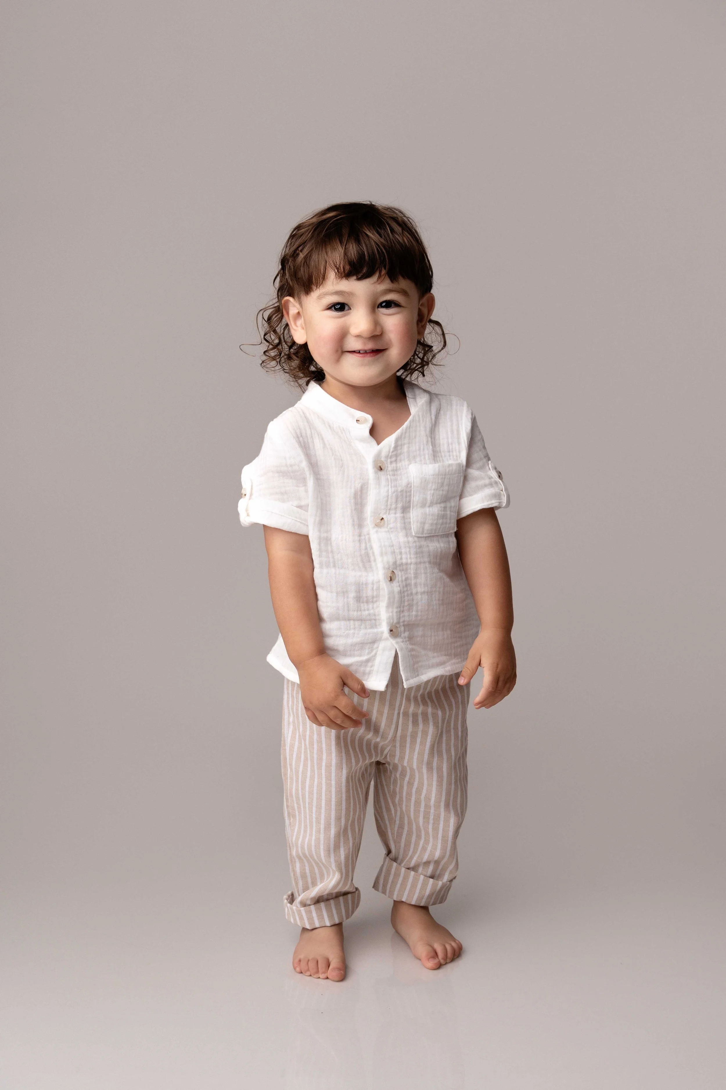 little boy smiling during his childrens photoshoot with lea cooper photography in wolverhampton in the west midlands