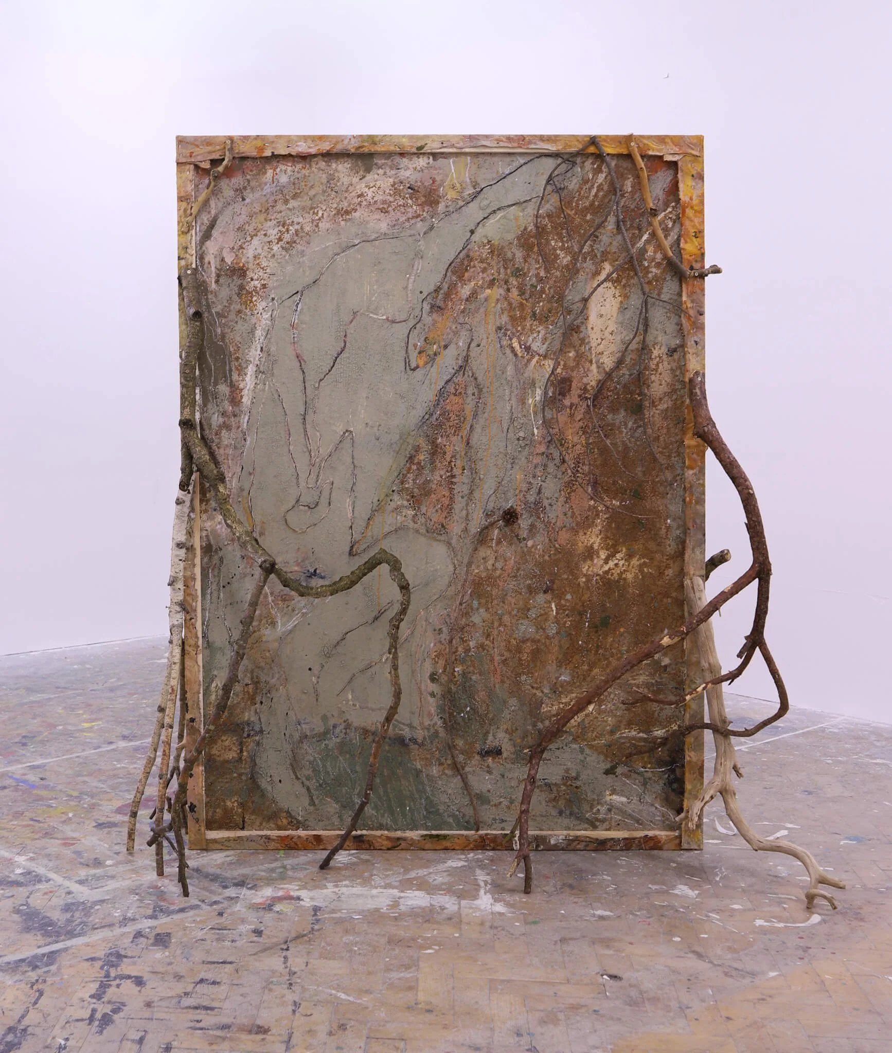 'Hibernation' is double-sided large sculptural painting that incorporates natural materials such clay, branches, crushed leaves.